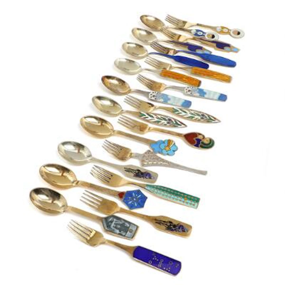 A collection of gilt sterling silver Christmas spoons and forks decorated
