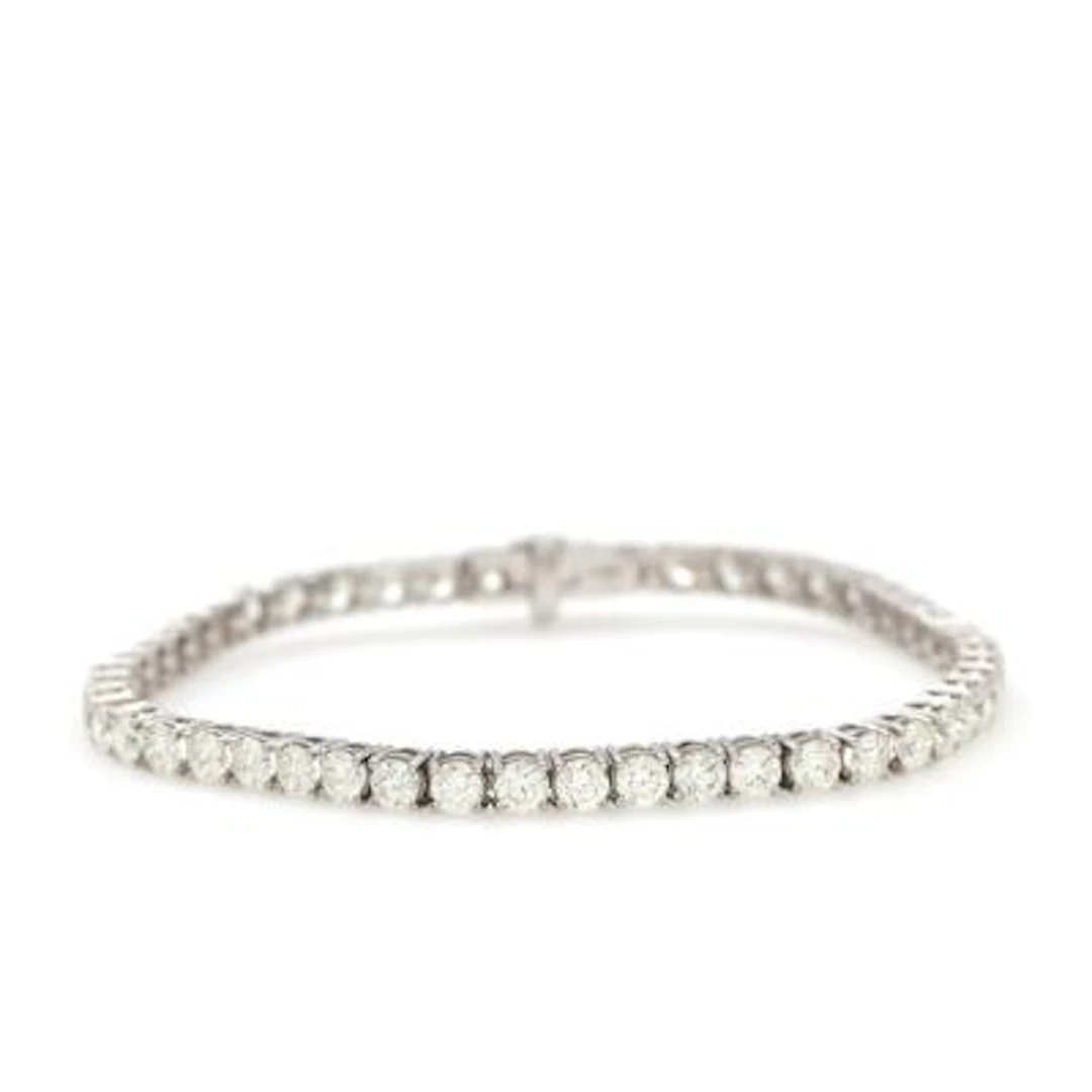 A diamond tennis bracelet set with 49 brilliant-cut diamonds weighing