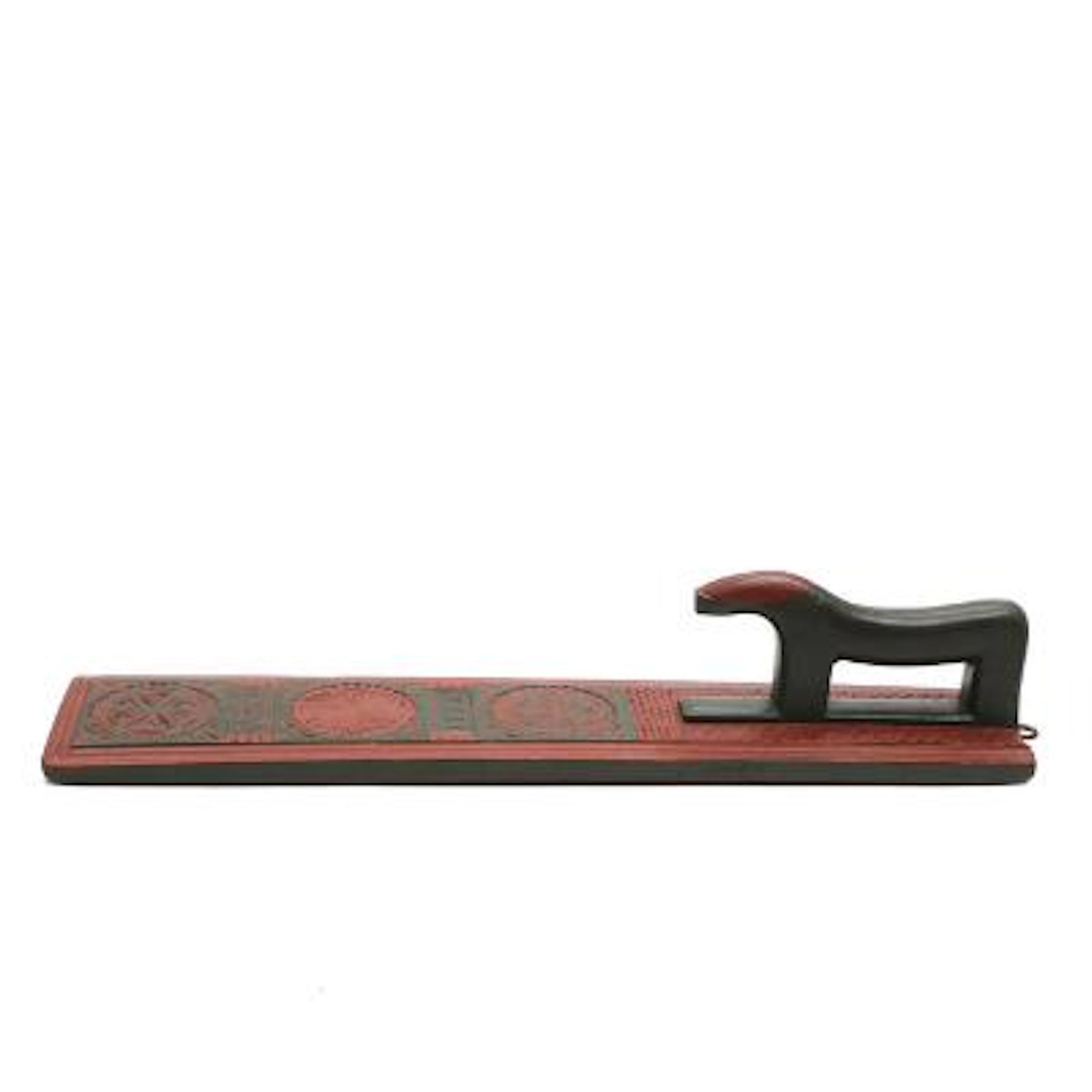 An 18th century red and green painted beech mangleboard, carved with