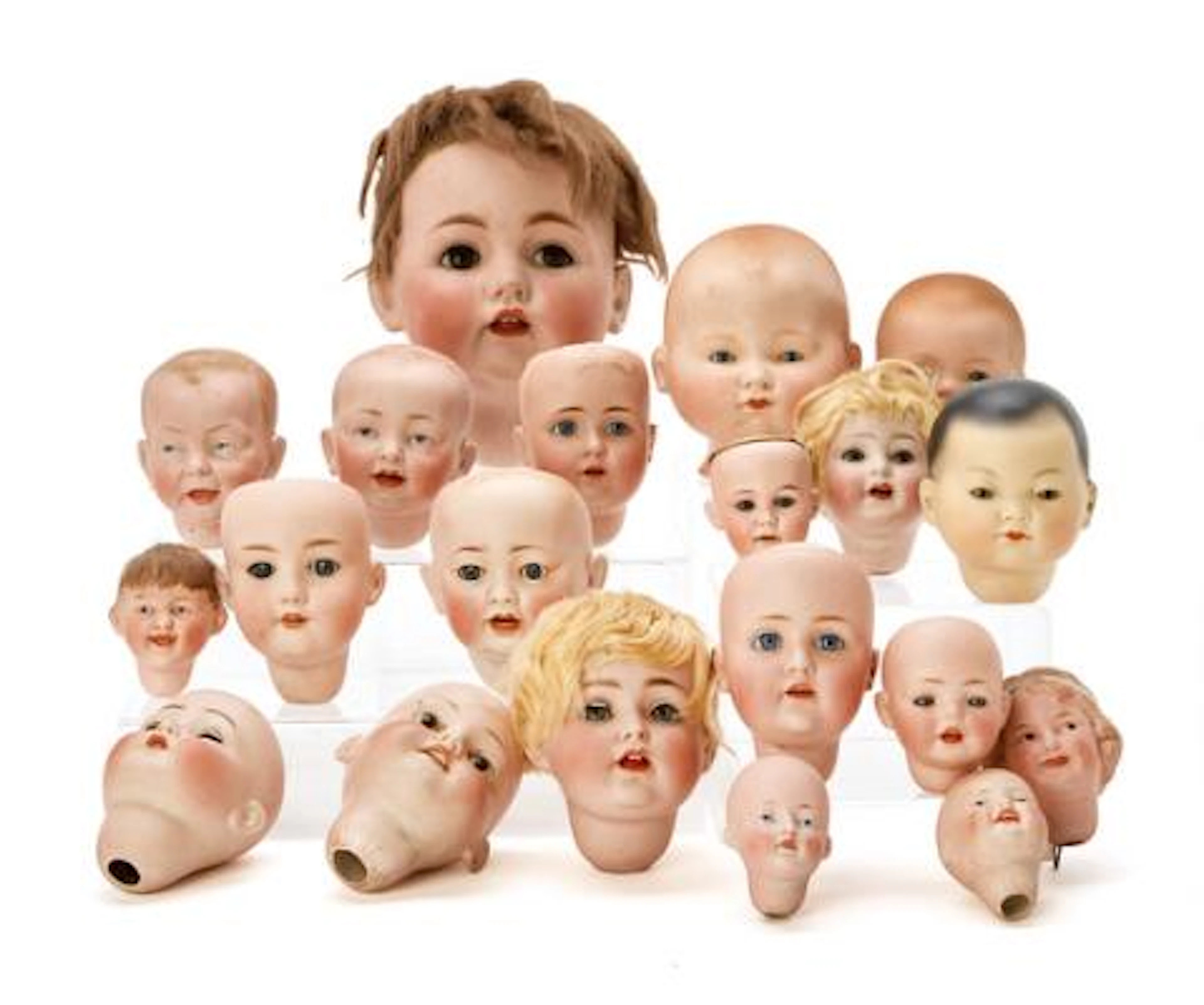 Collection of diverse German porcelain doll heads including Armand