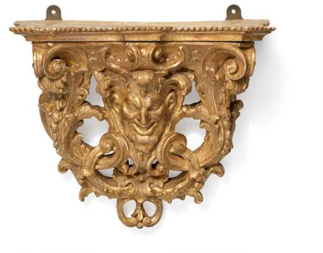 A Louis XV giltwood wall bracket console, carved with faun mask and