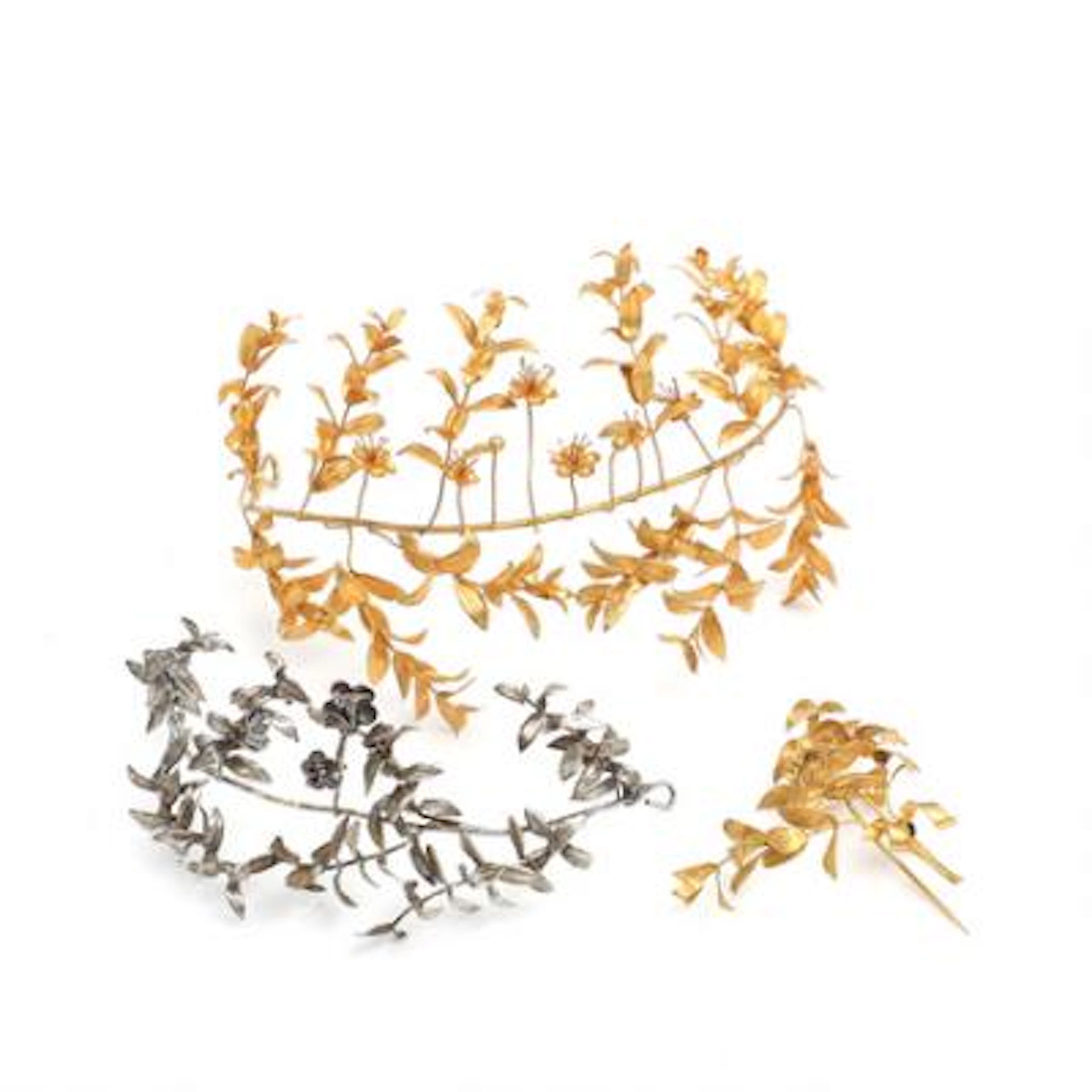 Two gilt and silvered metal bridal tiaras and corsage. Displayed in