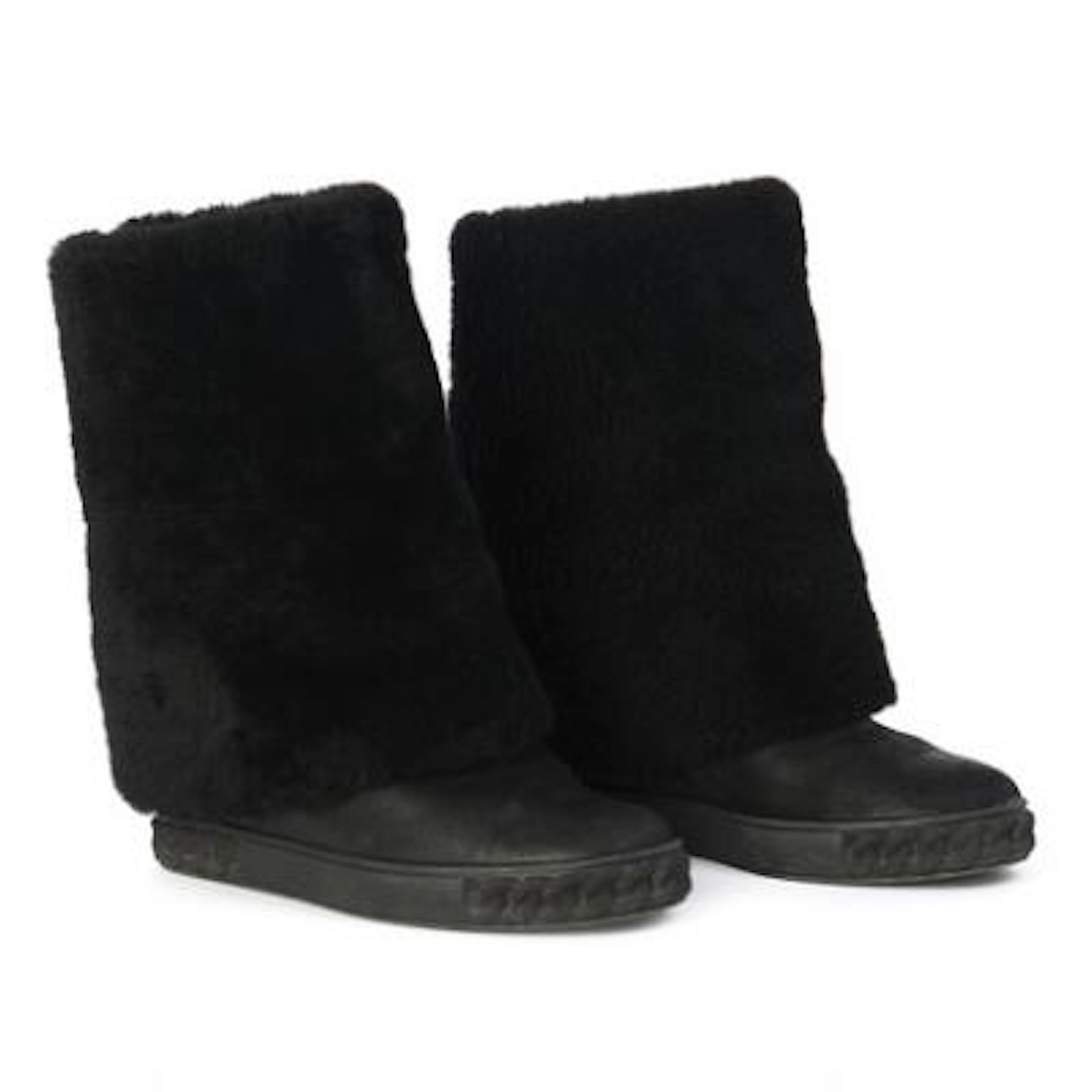 Casadei: A pair of black wedge boots of shearling and leather with