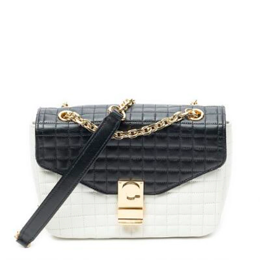 Céline: A bag of white and black quilted leather with gold-tone hardware.