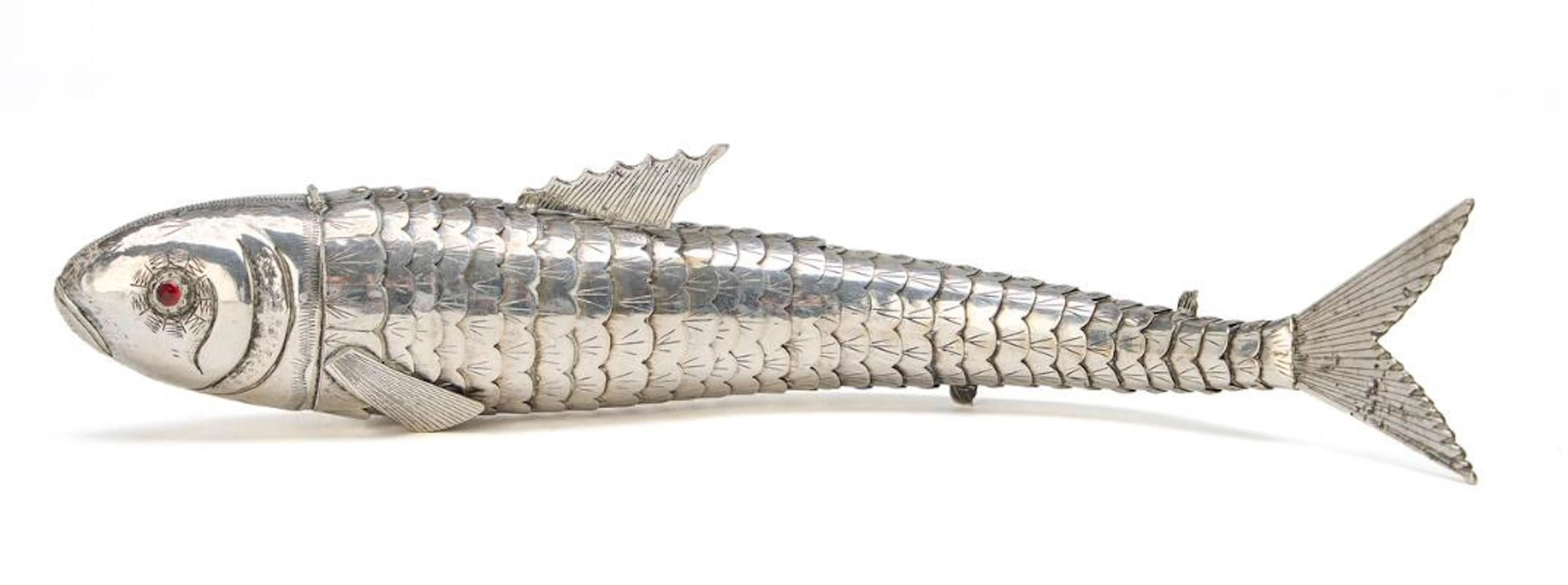A silver snuff box in the form of a fish, eyes of red glass. Stamped