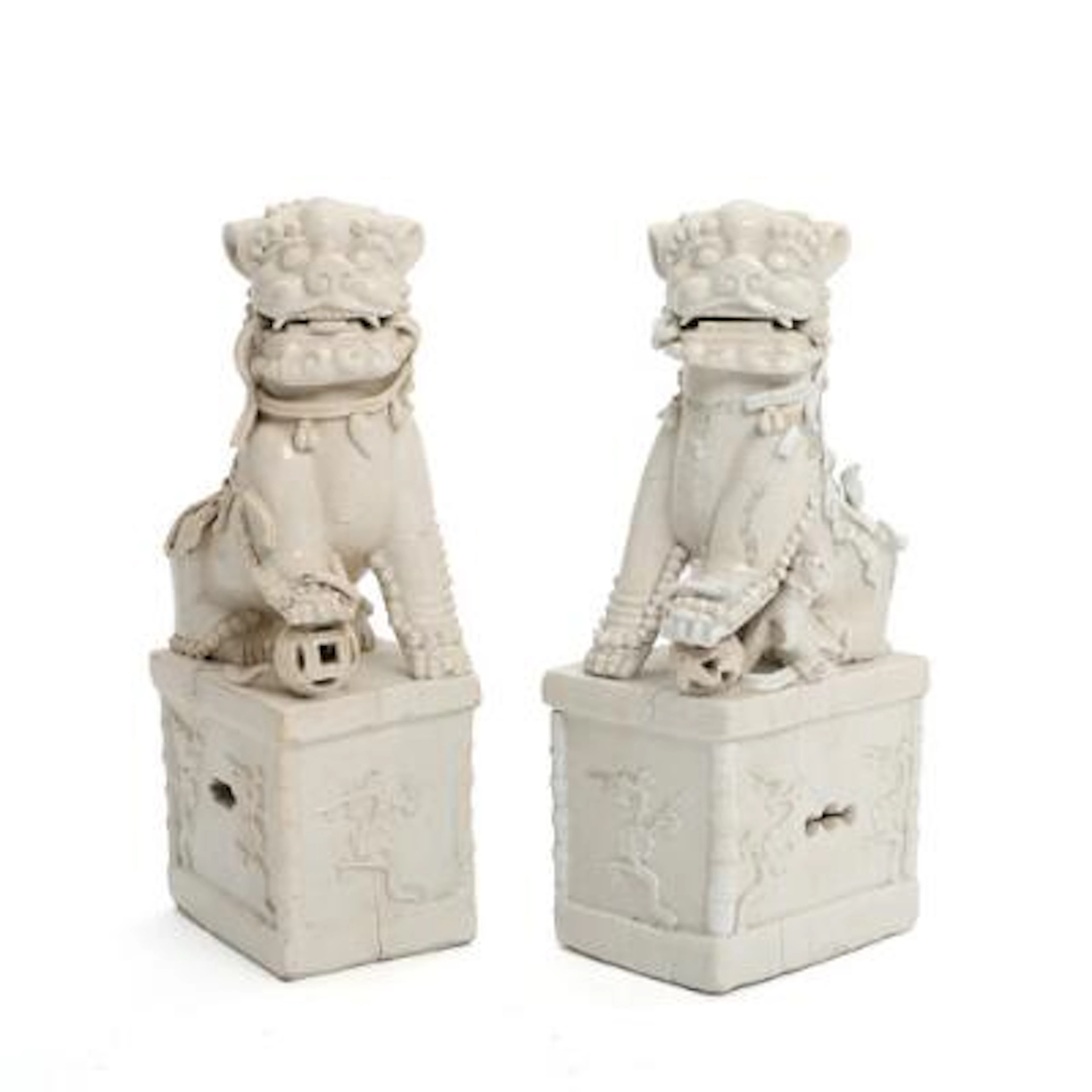 A pair of Chinese foo dogs in porcelain, seated on pedestals. Qing
