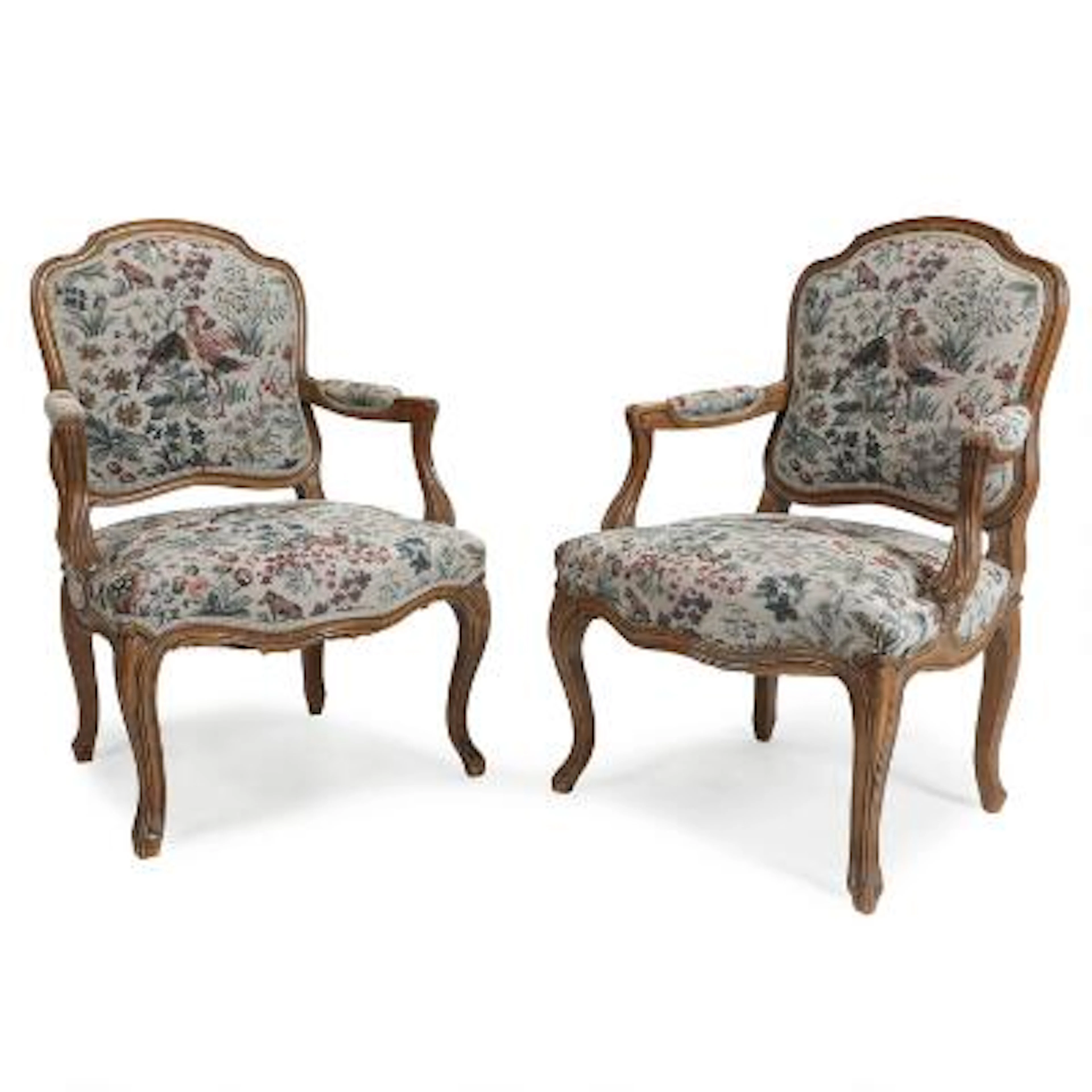 A pair of Louis XVI style walnut armchairs, upholstered with embroidered