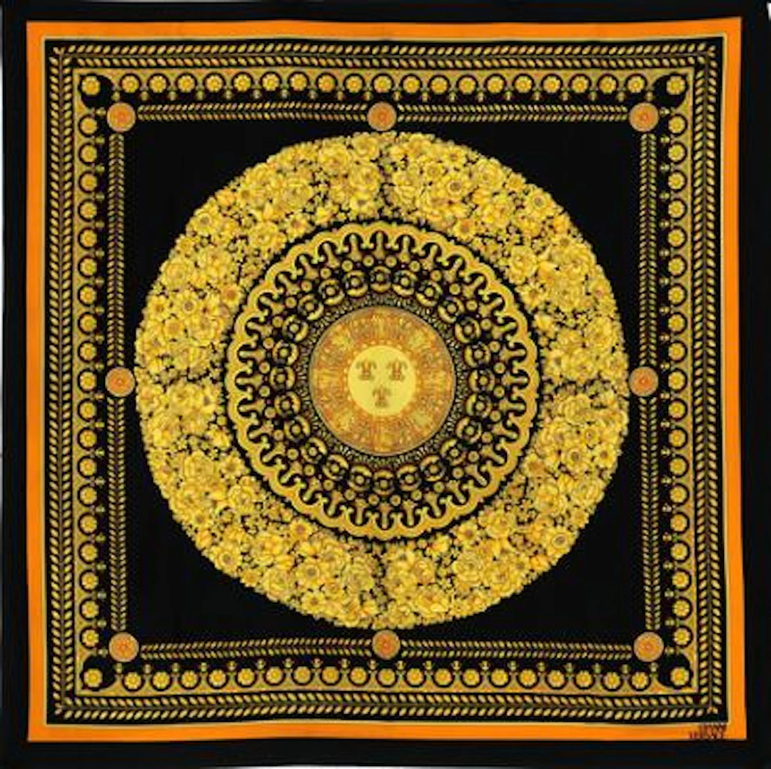Versace: A vintage silk scarf with yellow and orange motif on black