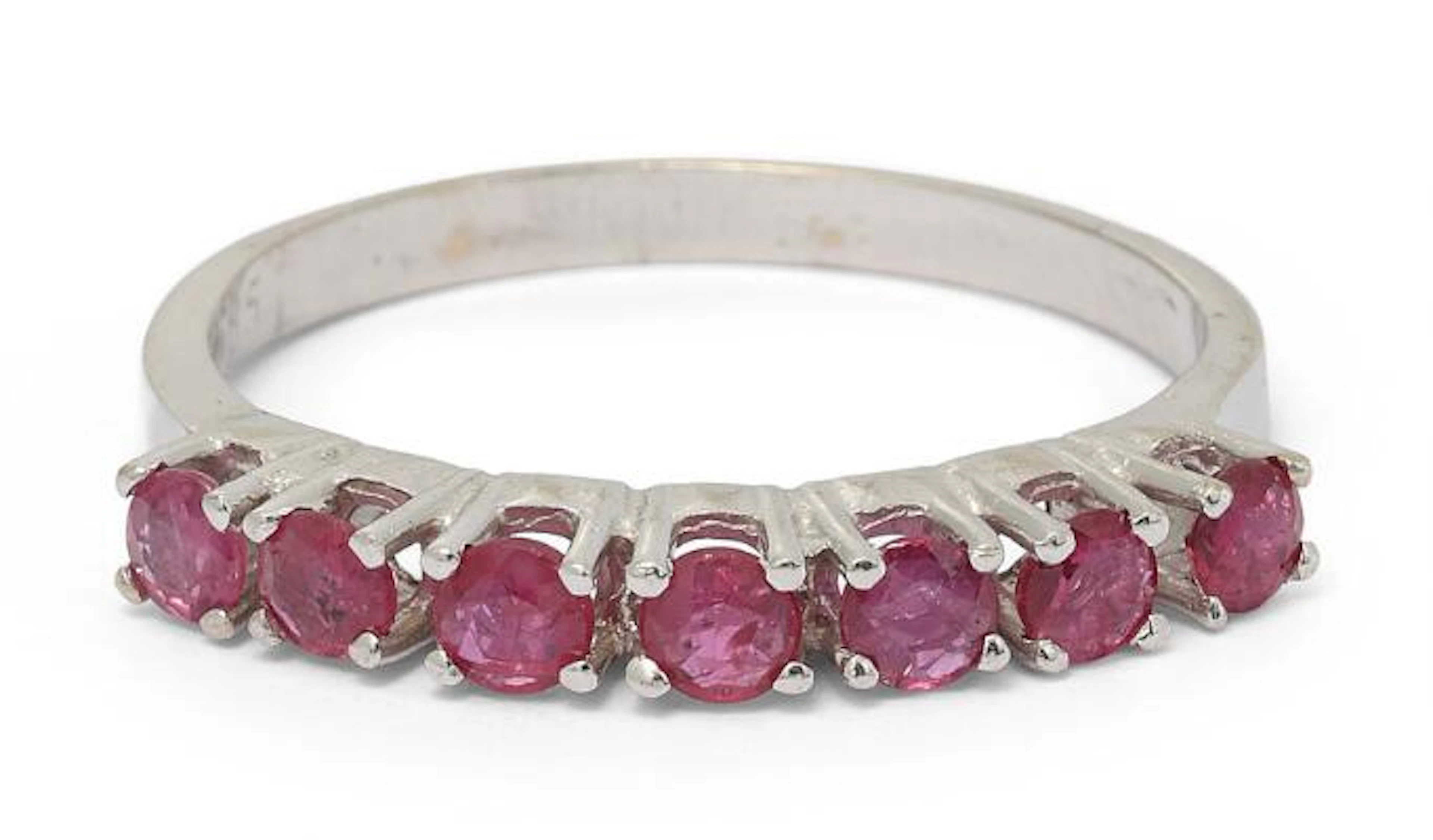 A ruby ring set with numerou circular-cut rubies, mounted in 14k white