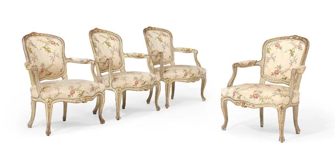 A set of four French Rococo armchairs of gilded and painted wood.
