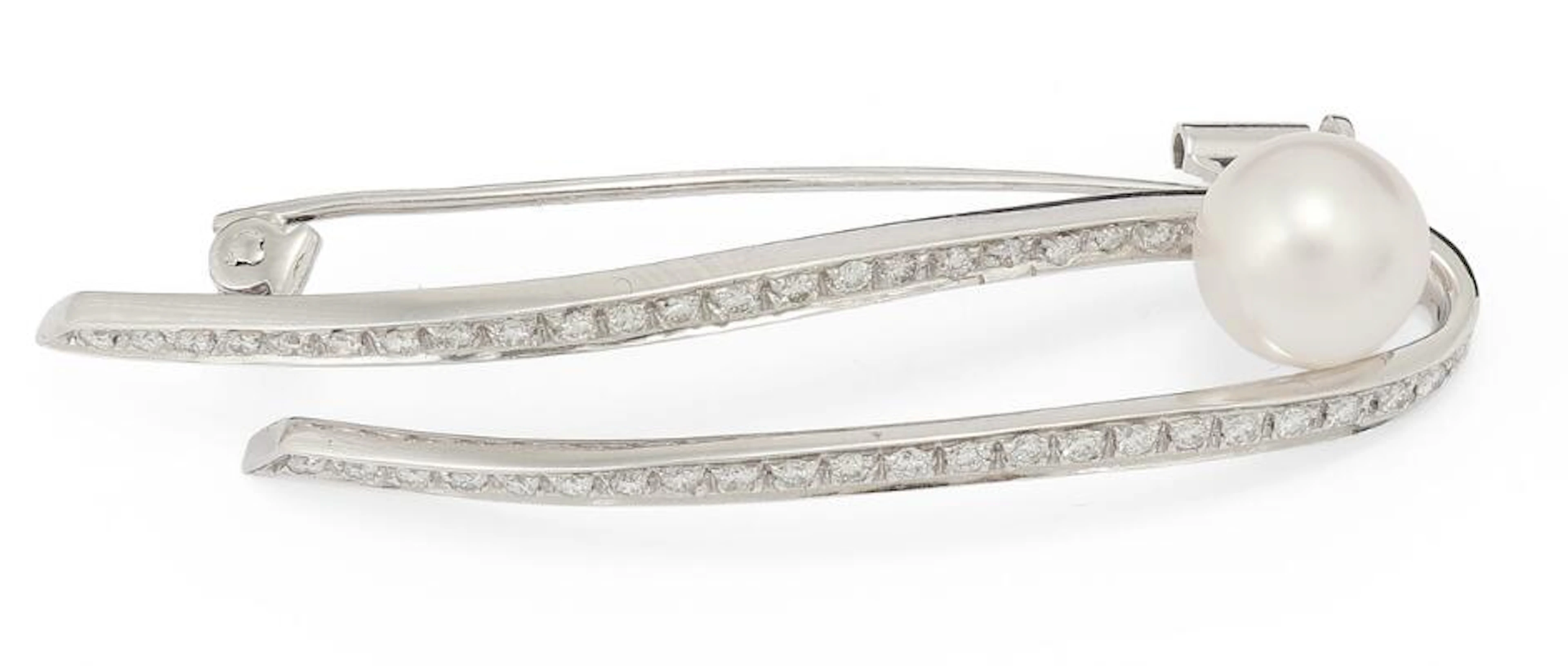 A pearl and diamond brooch set with a cultured freshwater pearl and