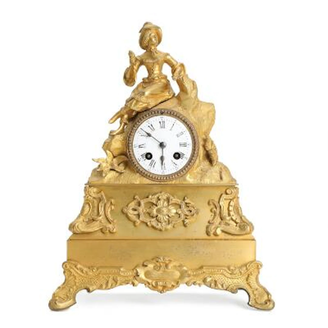 French mantel clock of gilded bronze, decorated with a woman. White