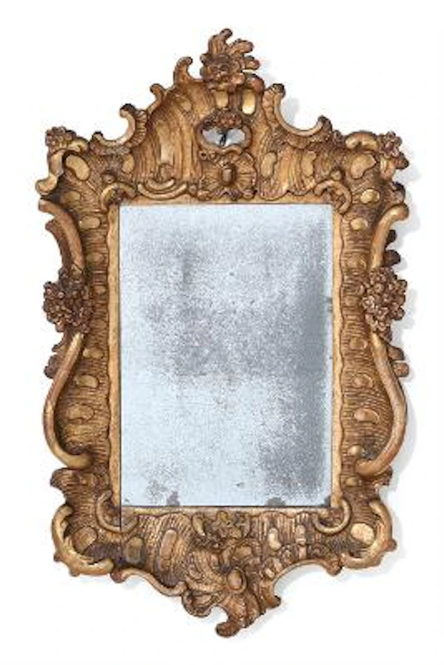 A small Rococo giltwood mirror, carved with scrollwork, combings and