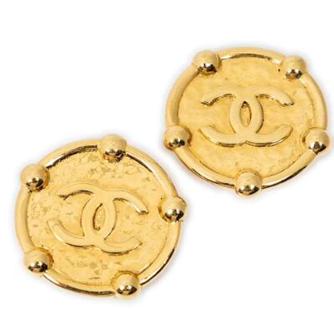 Chanel: A pair of ear clips of gold-toned metal set with CC logo.