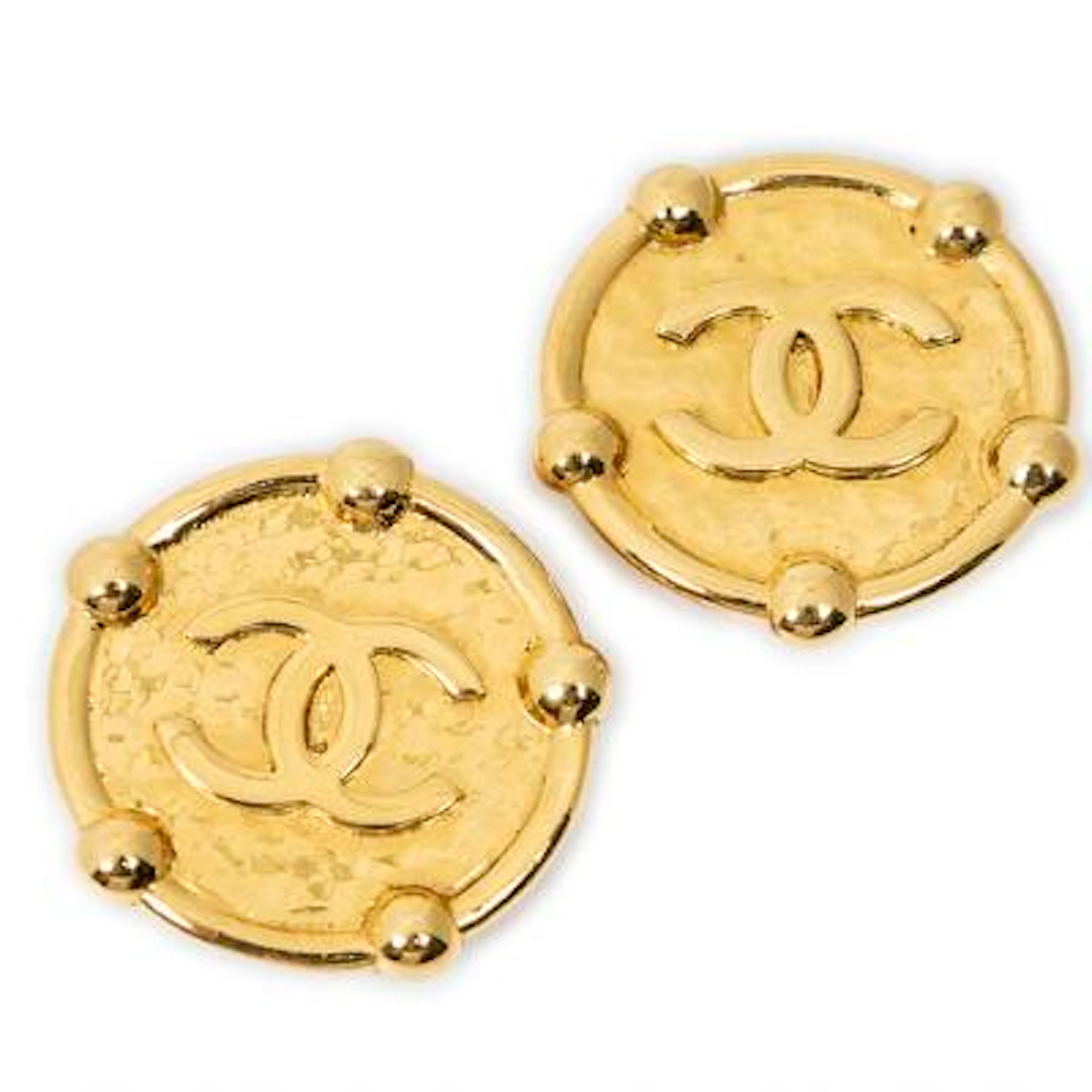 Chanel: A pair of ear clips of gold-toned metal set with CC logo.