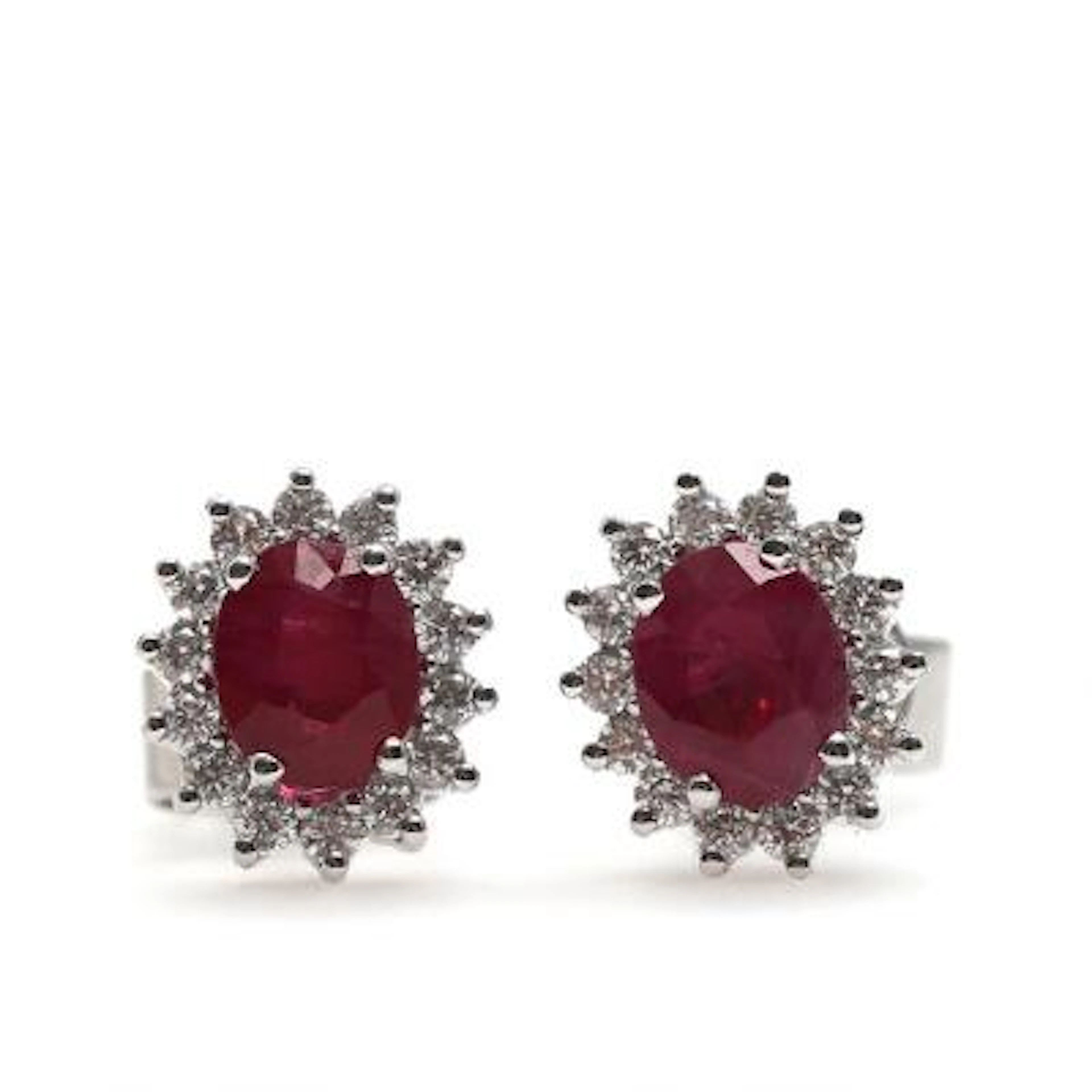 A pair of ruby ​​and diamond ear studs each set with a faceted ruby