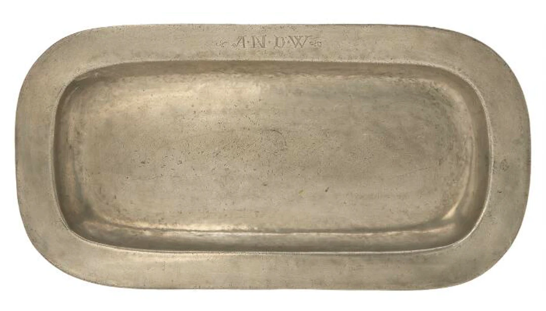 A large pewter dish of oval form. Engraved with owner initials. L.