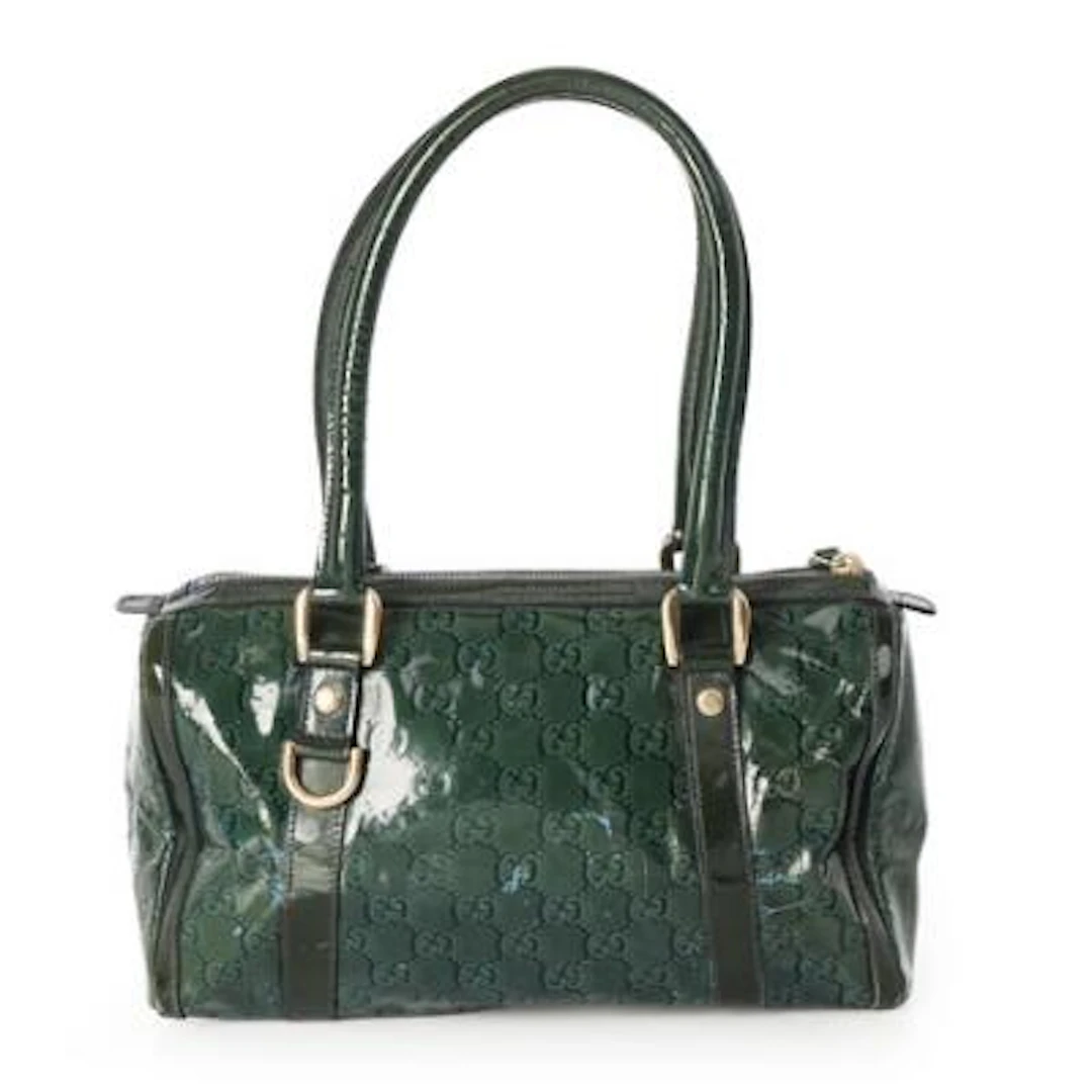 Gucci: A bag of dark green monogram coated canvas with gold tone hardware