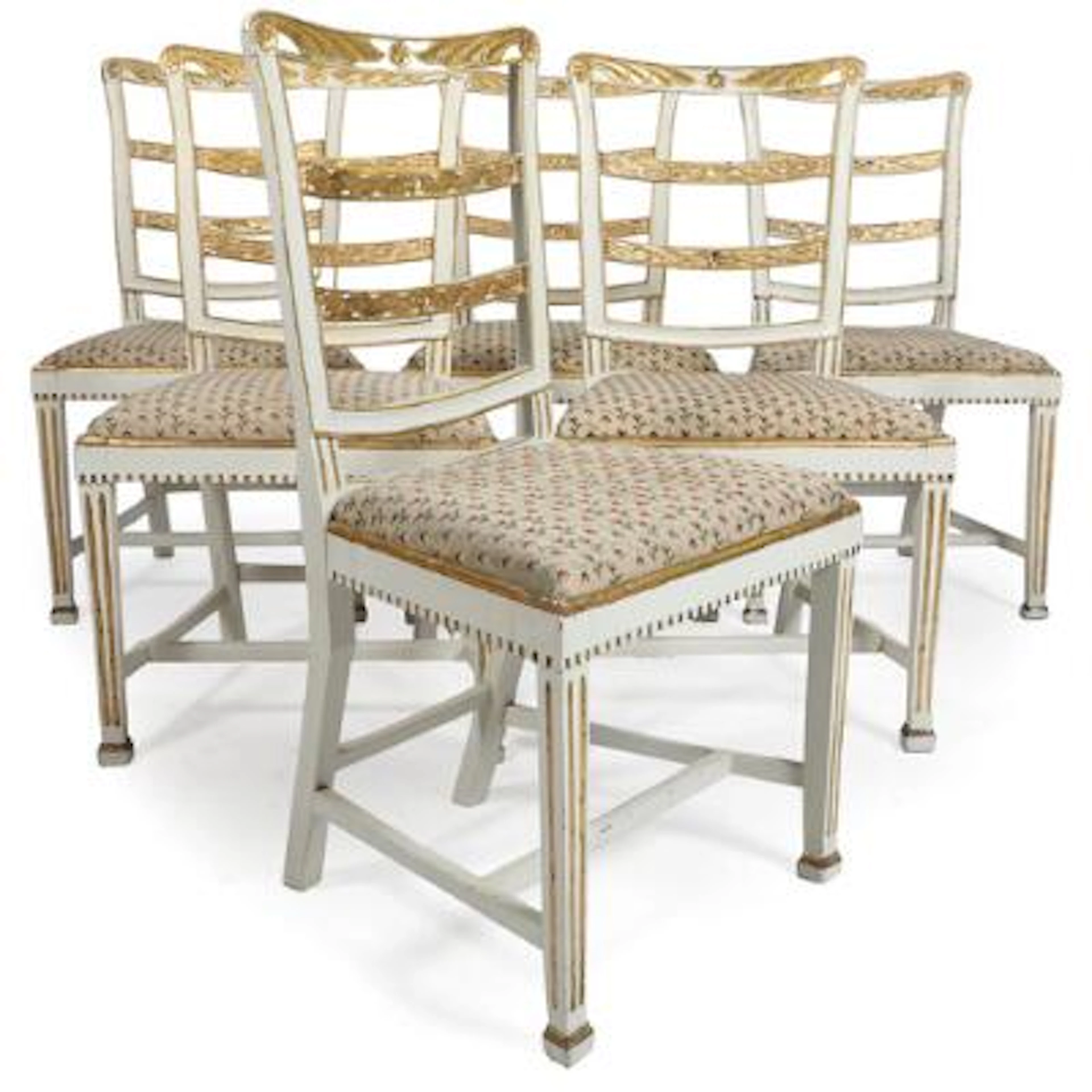 A set of six French Louis XVI chairs of white-painted and gilt wood.