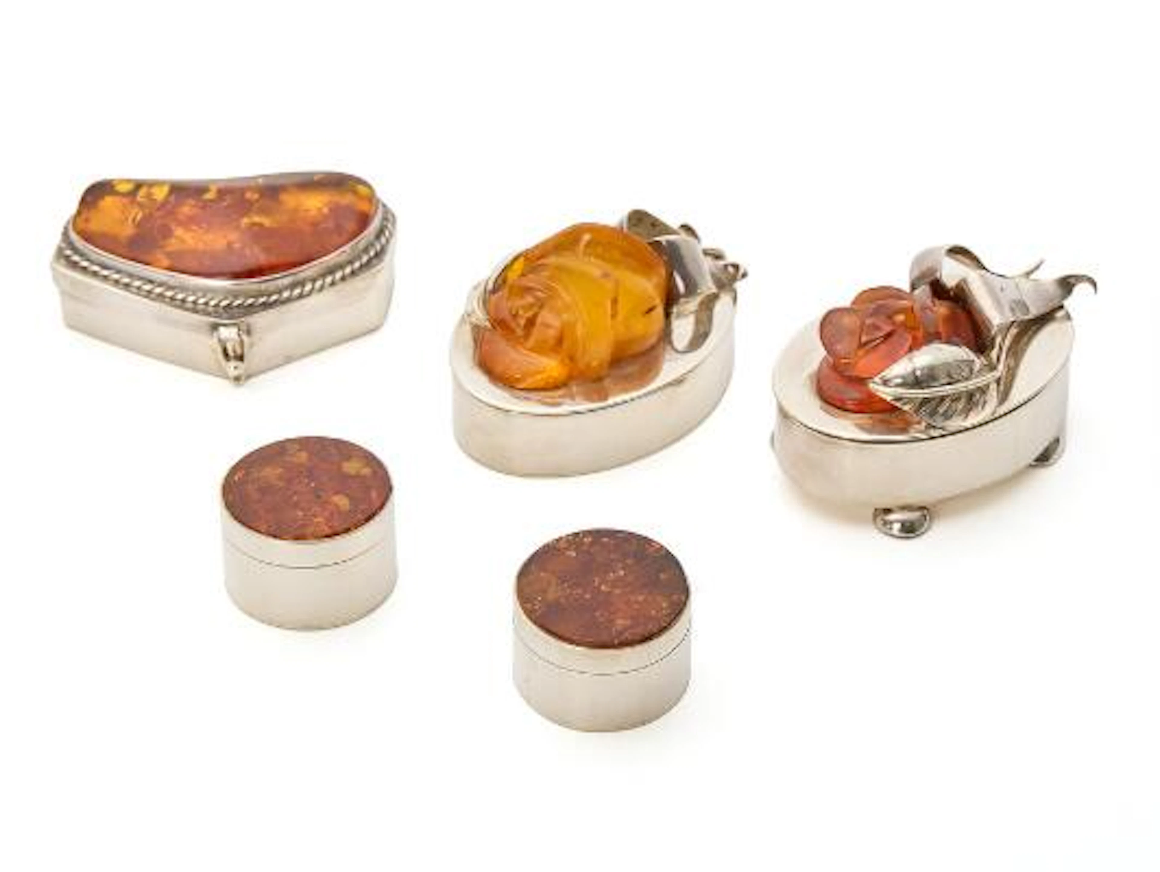 Five boxes of sterling silver adorned with pieces of carved amber.
