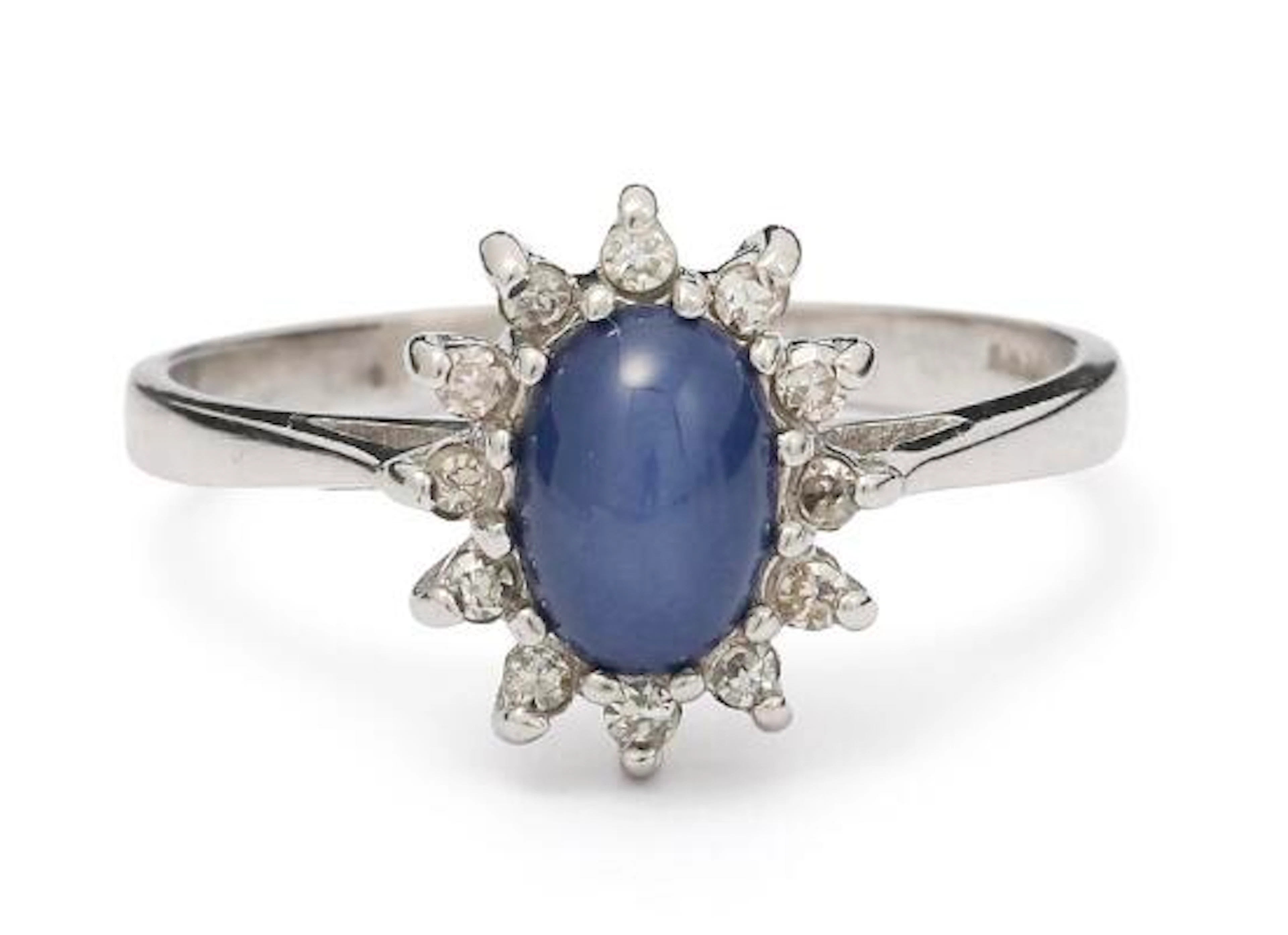 A sapphire and diamond ring set with a star sapphire and single-cut