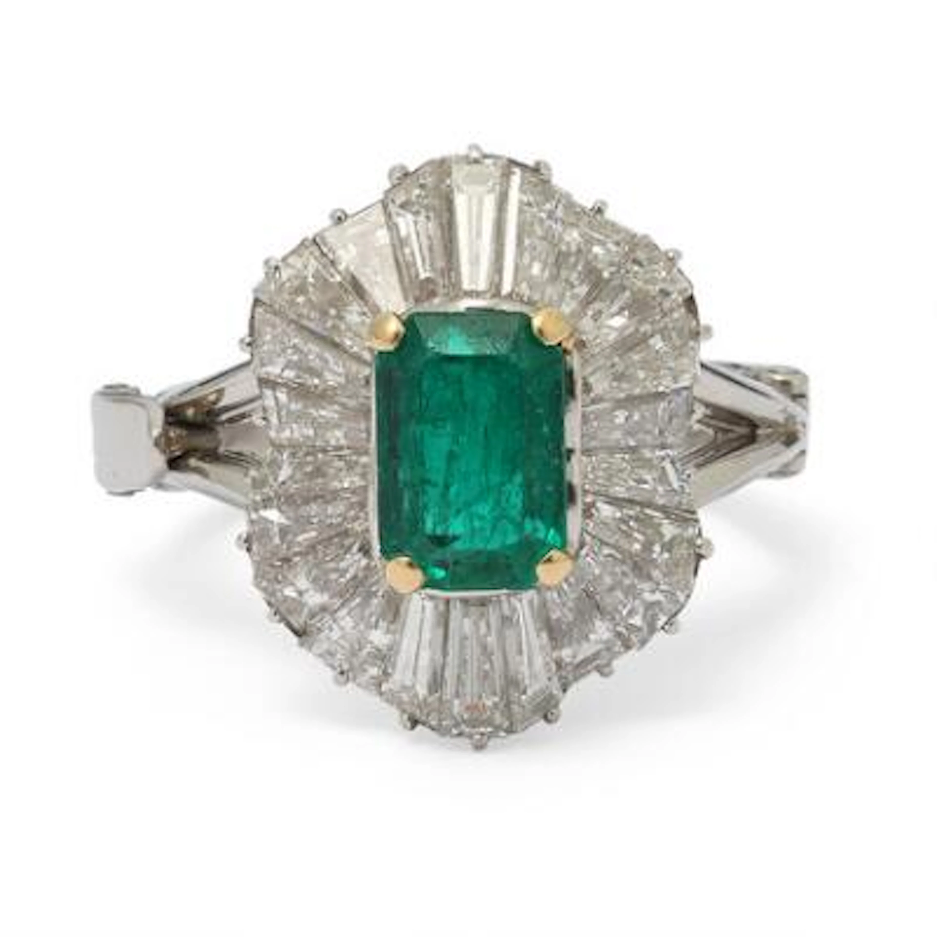 An emerald and diamond ring set with an emerald encircled by diamonds