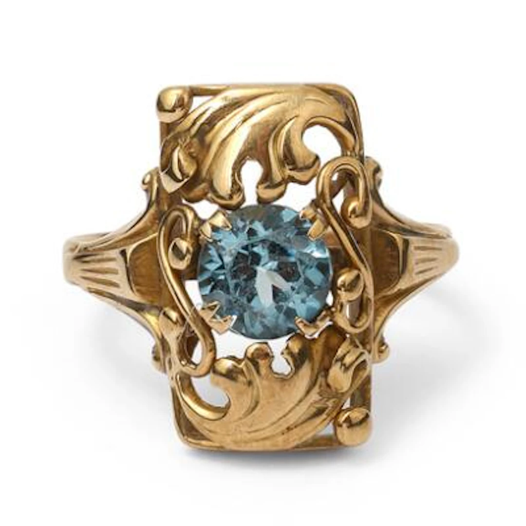 A spinel ring set with a circular-cut synthetic blue spinel, mounted