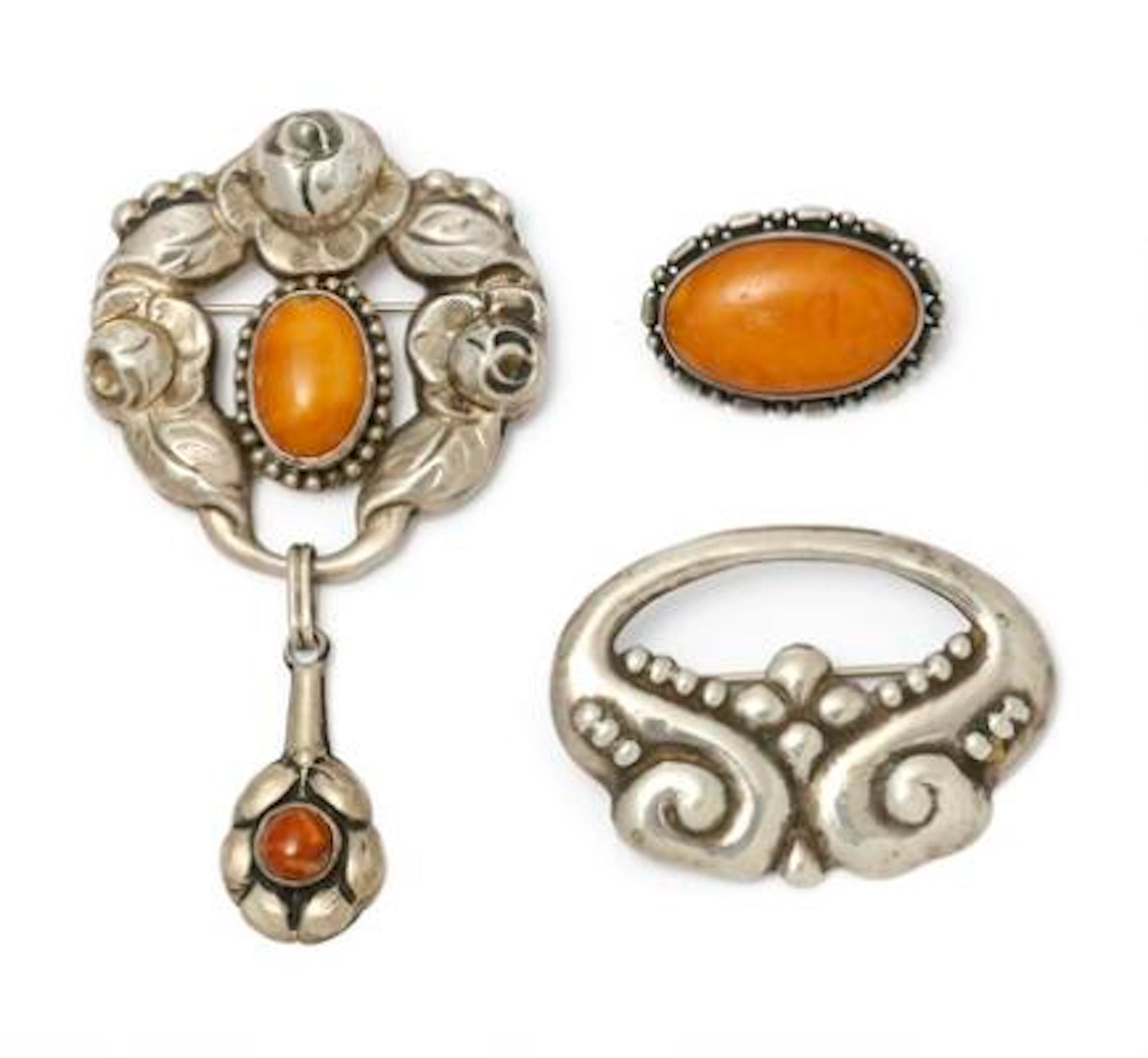 Three Art Nouveau silver brooches of which two are set with bpolished