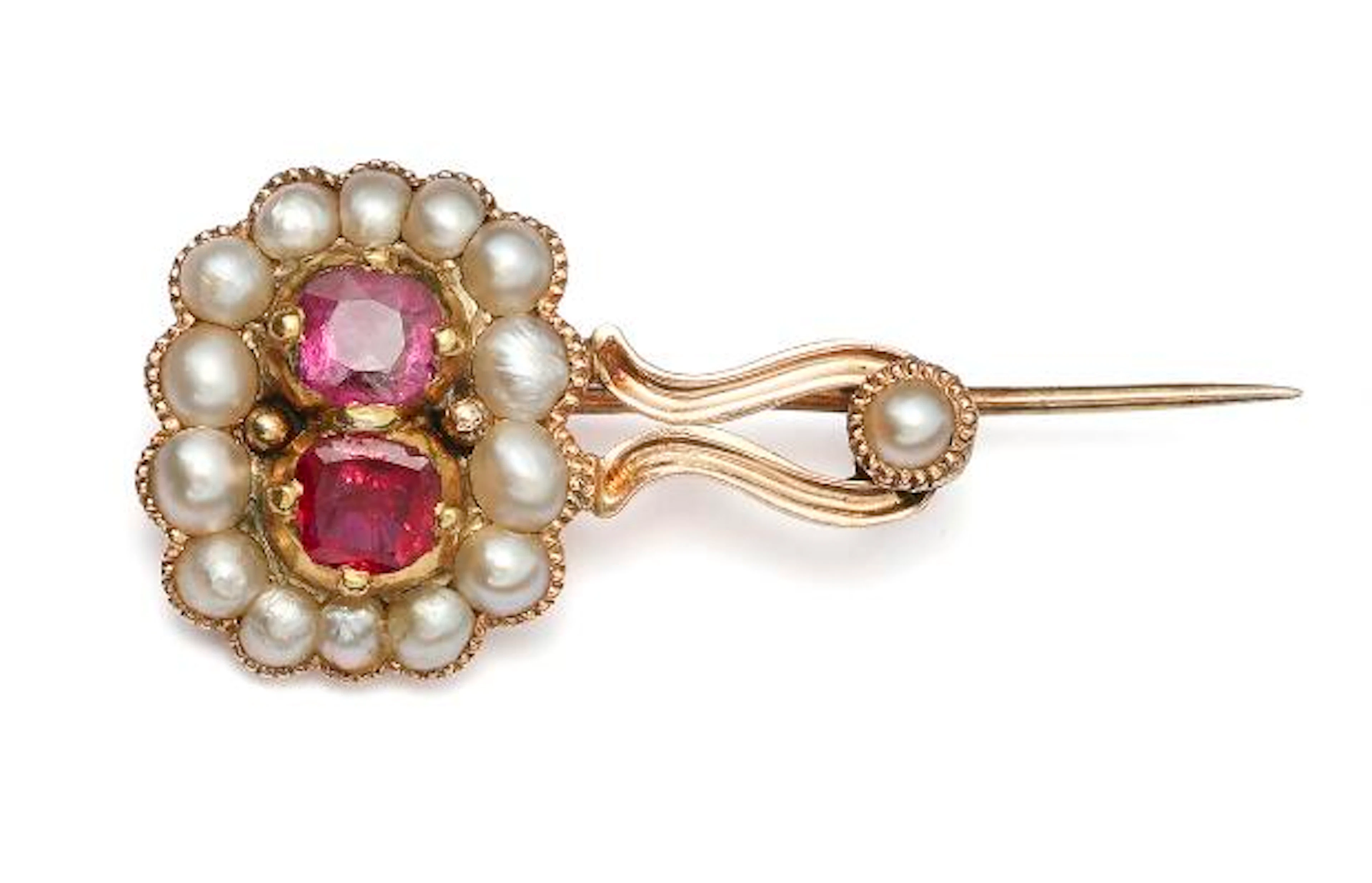 A sapphire and pearl brooch set with two pink sapphires and seed pearls