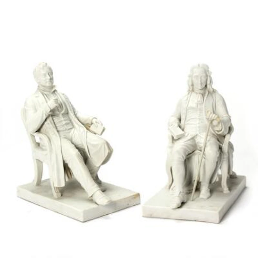 A pair of biscuit figurines depicting Ludvig Holberg and Adam Oehlenschläger.