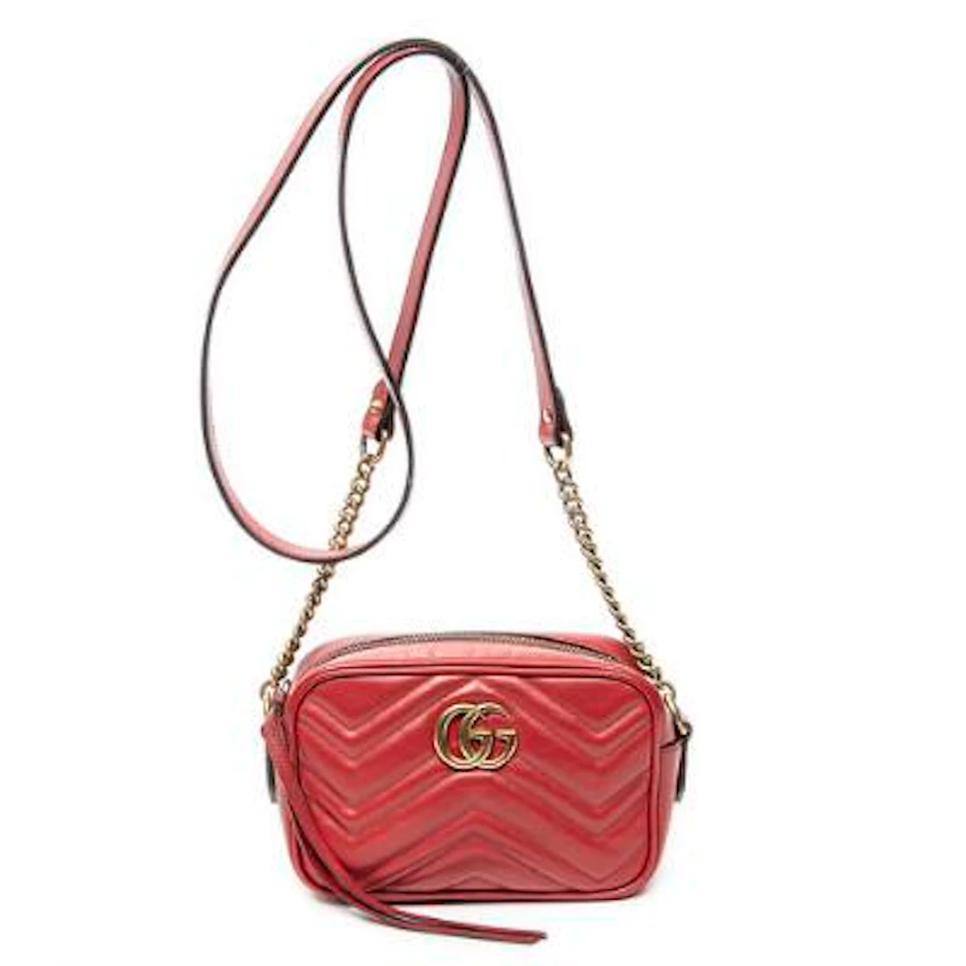 Gucci: A "Mini GG Marmont Camera Crossbody" bag in red quilted Chevron-leather