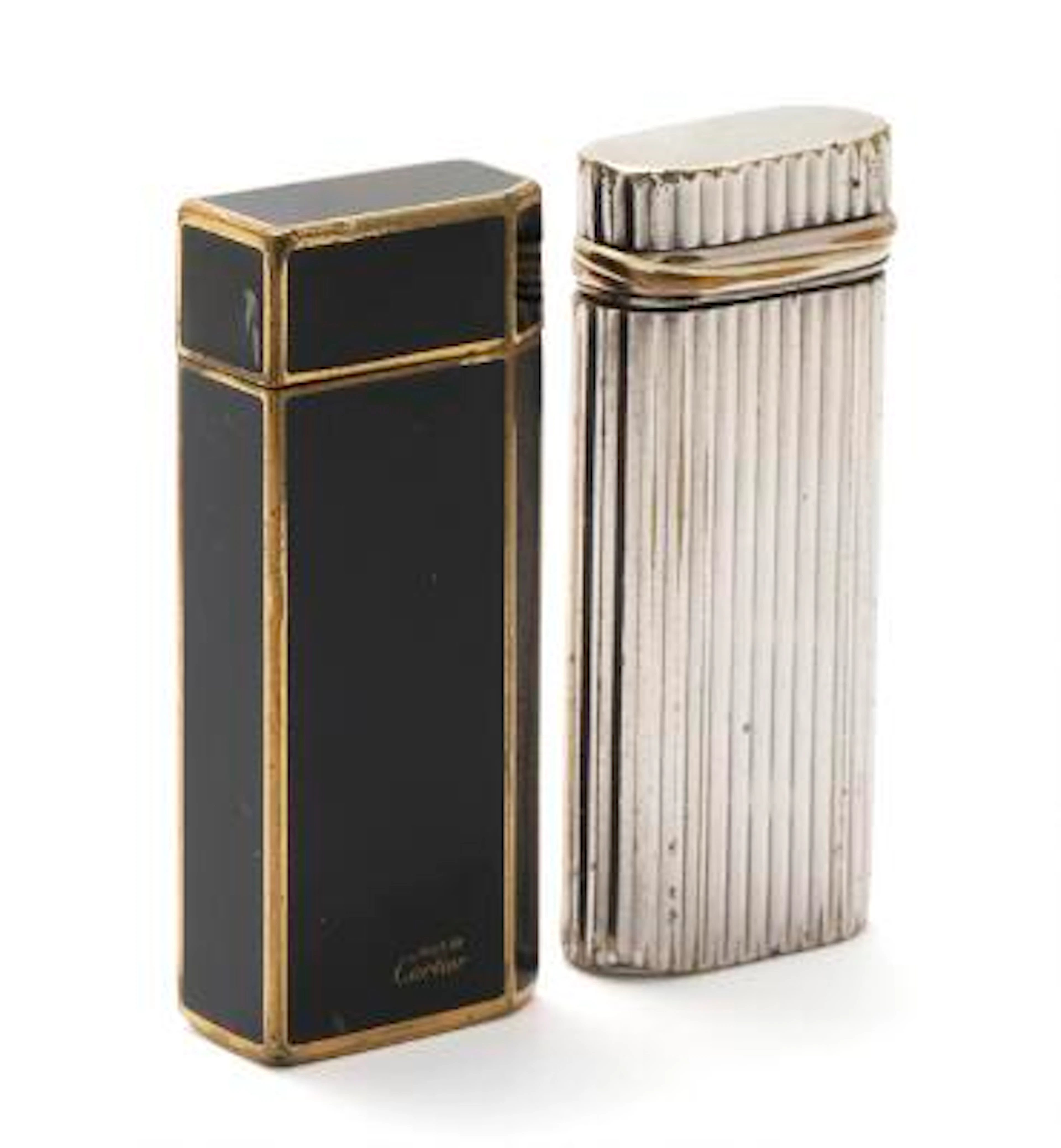 Cartier: A "Must de Cartier" gilded lighter set with black laquer