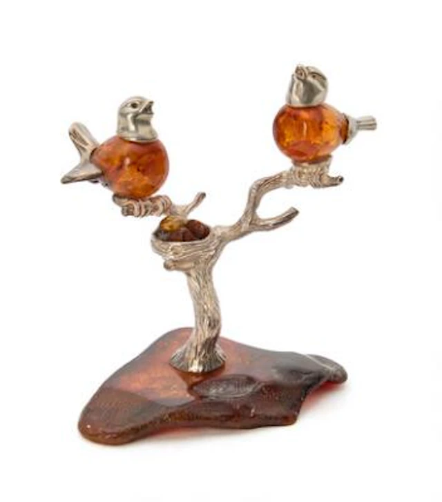 Figurine group of carved amber adorned with silver in the form of