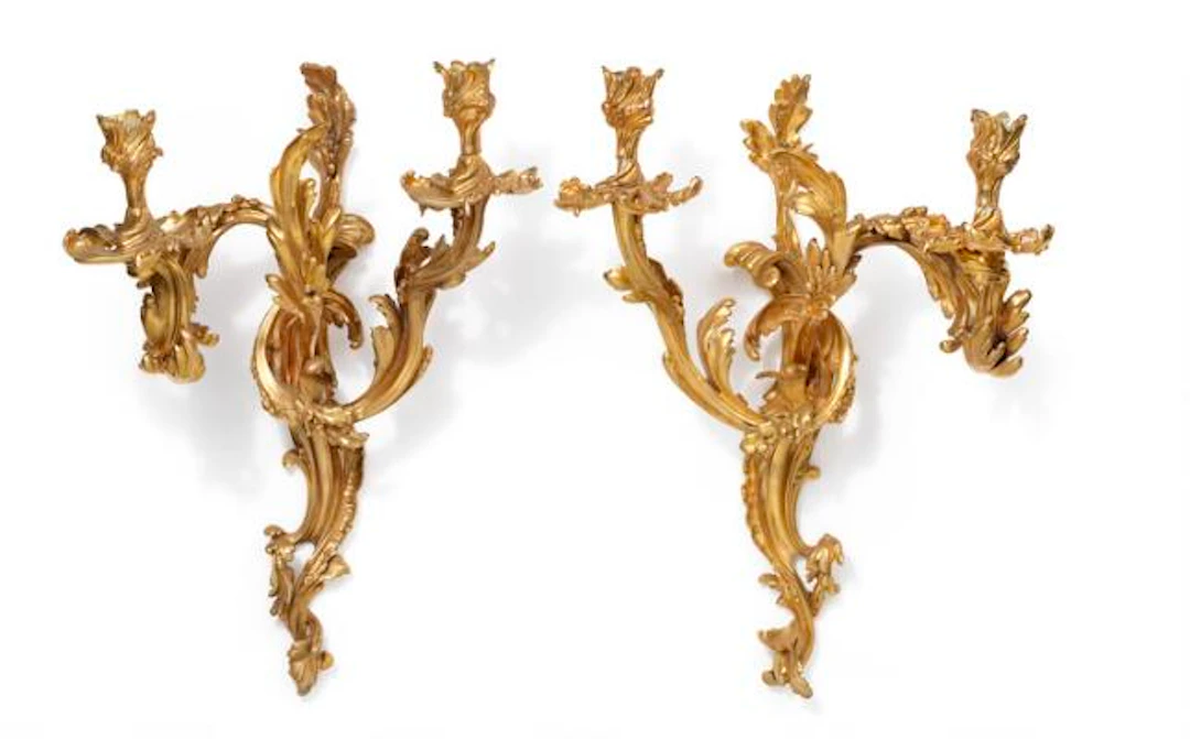 A pair of large Louis XV style gilt bronze wall lights, each with