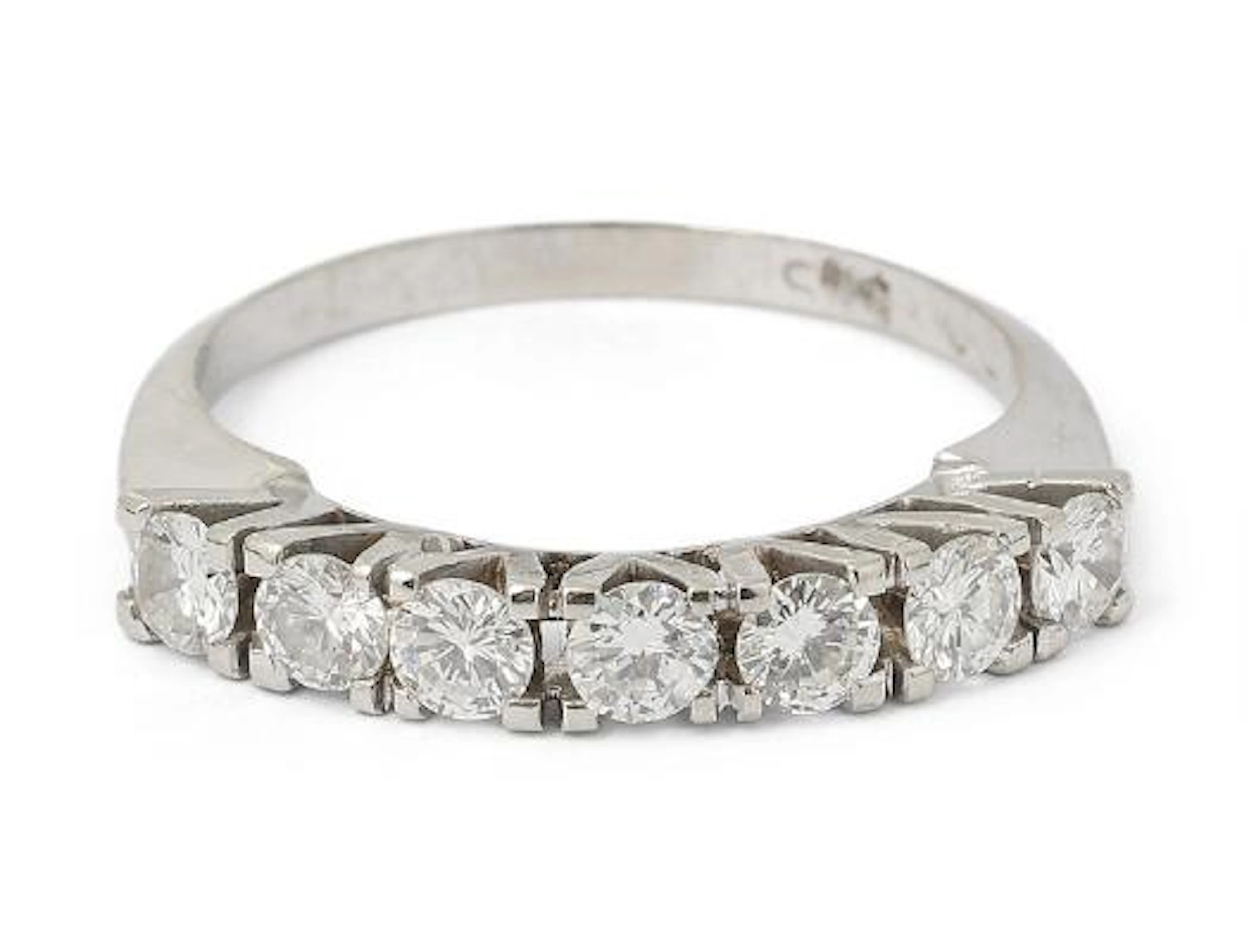 A diamond ring set with seven brilliant-cut diamonds, mounted in 14k