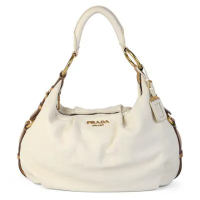 Prada: A bag of white and brown leather with gold tone hardware, short