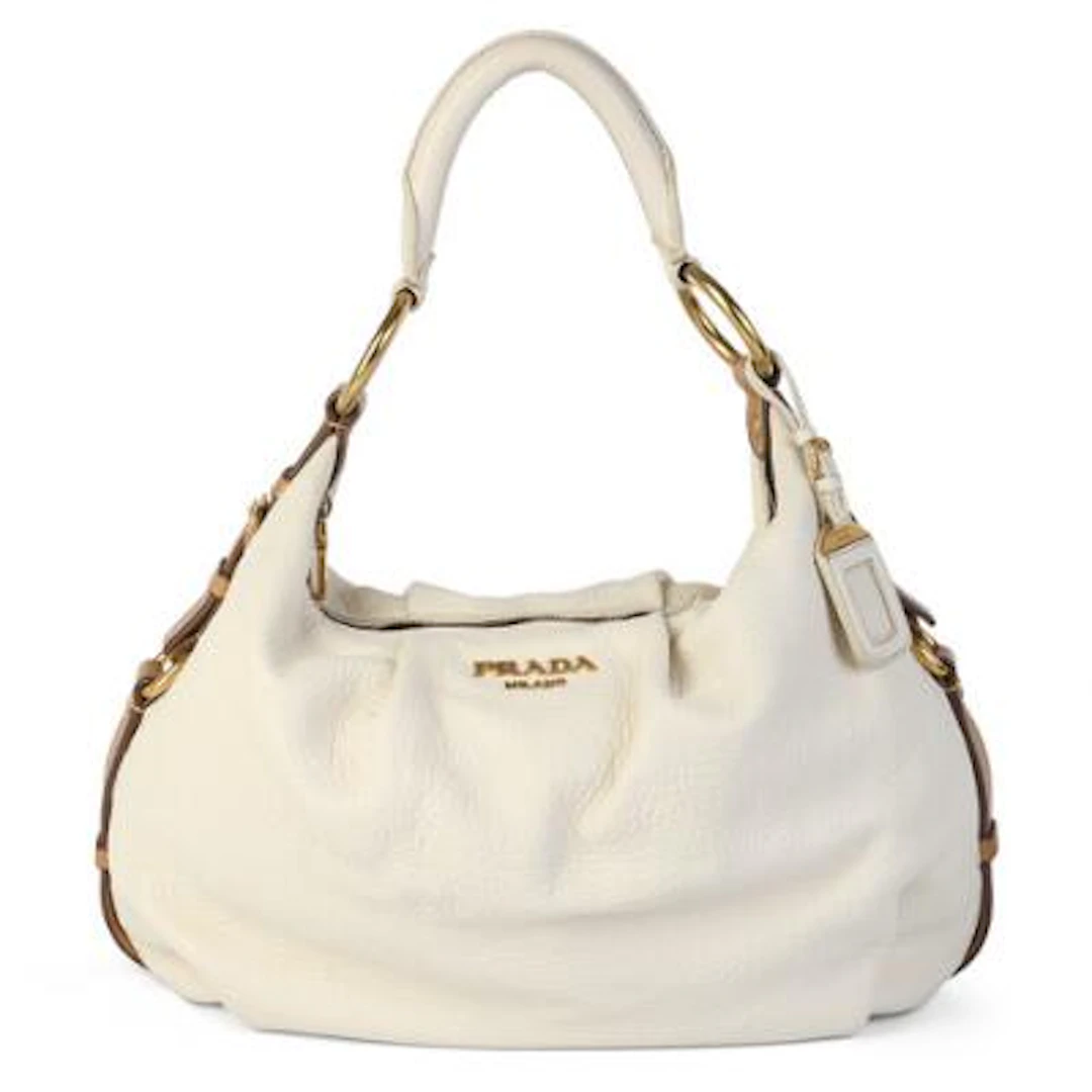 Prada: A bag of white and brown leather with gold tone hardware, short