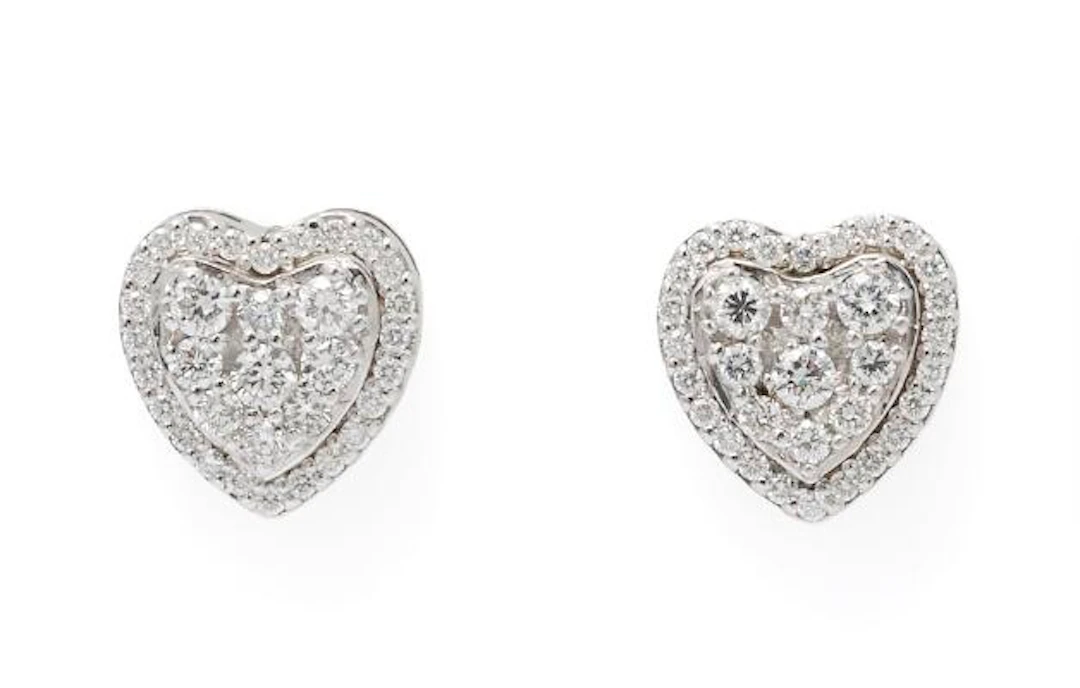 A pair of diamond ear studs in the shape of a heart set with numerous