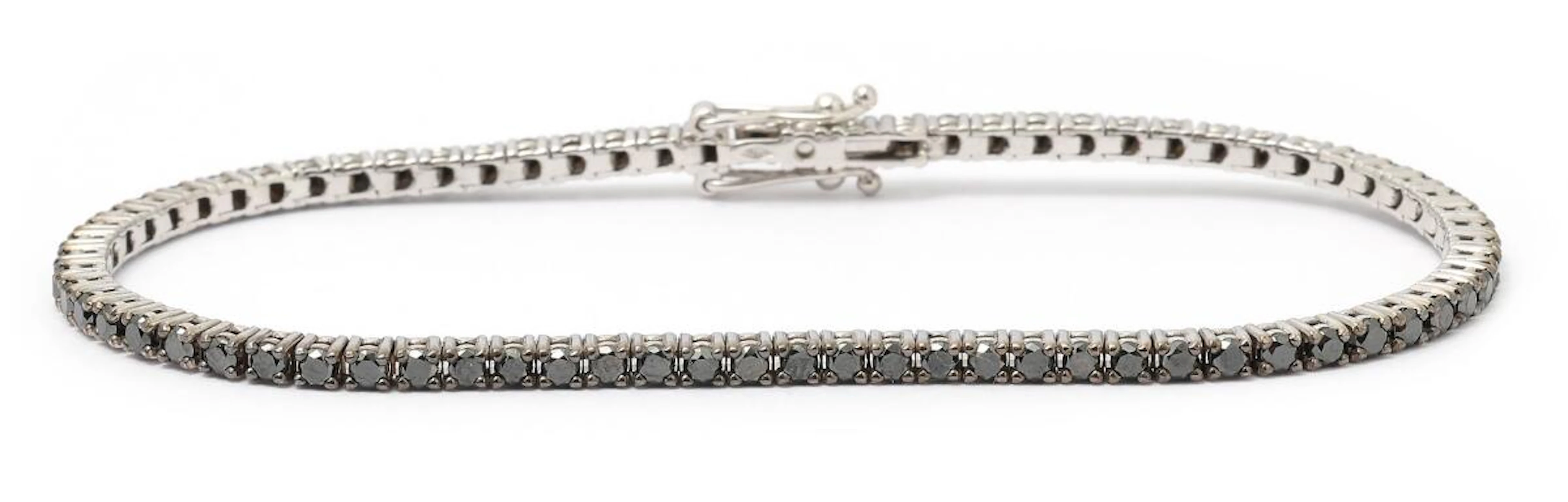 A diamond bracelet set with numerous black diamonds, mounted in 18k