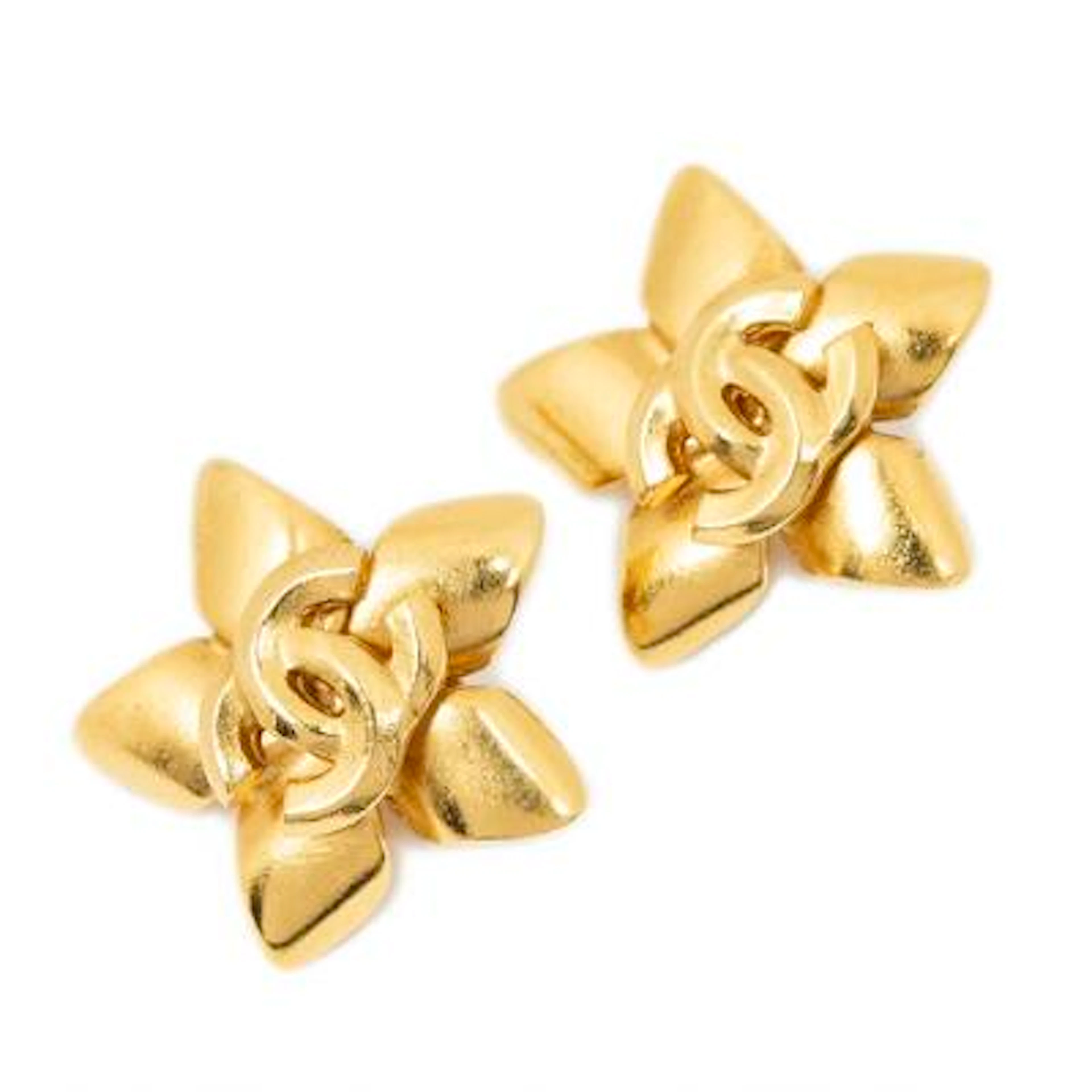 Chanel: A pair of earclips of gold-toned metal each set with CC logo.