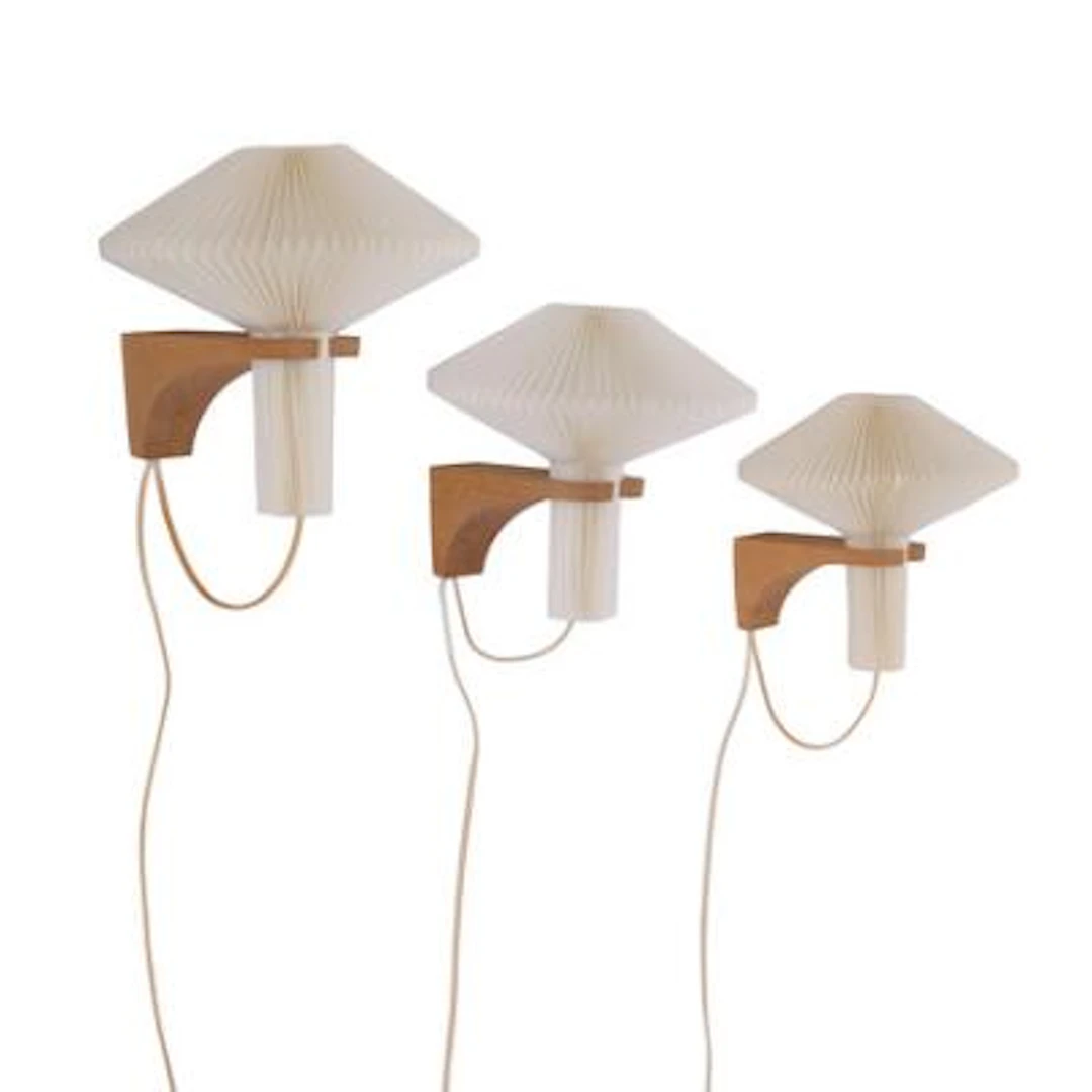 Le Klint, Vilhelm Wohlert: Three wall lamps of oak. Shade of pleated