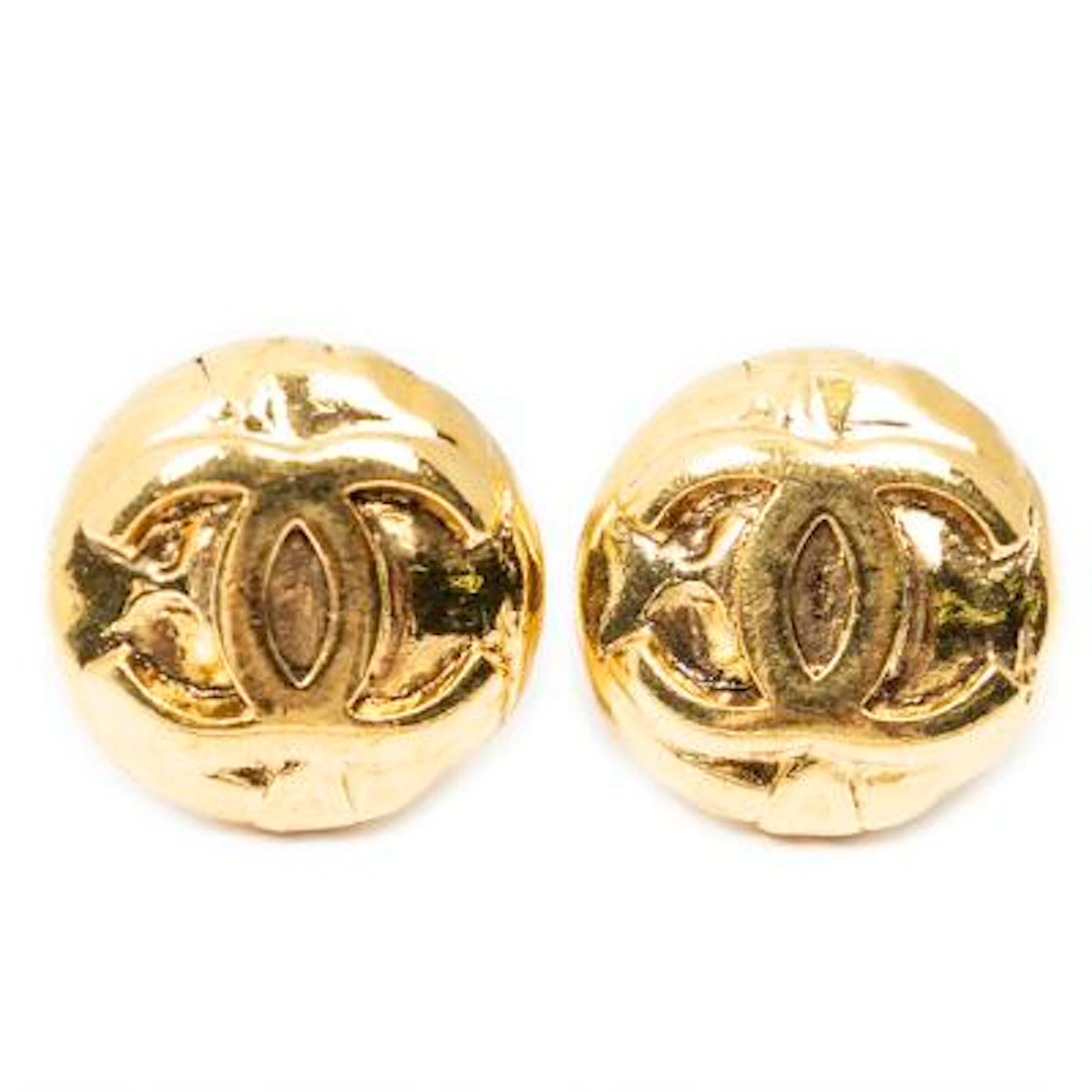 Chanel: A pair of ear clips in gold-toned metal each set with a CC