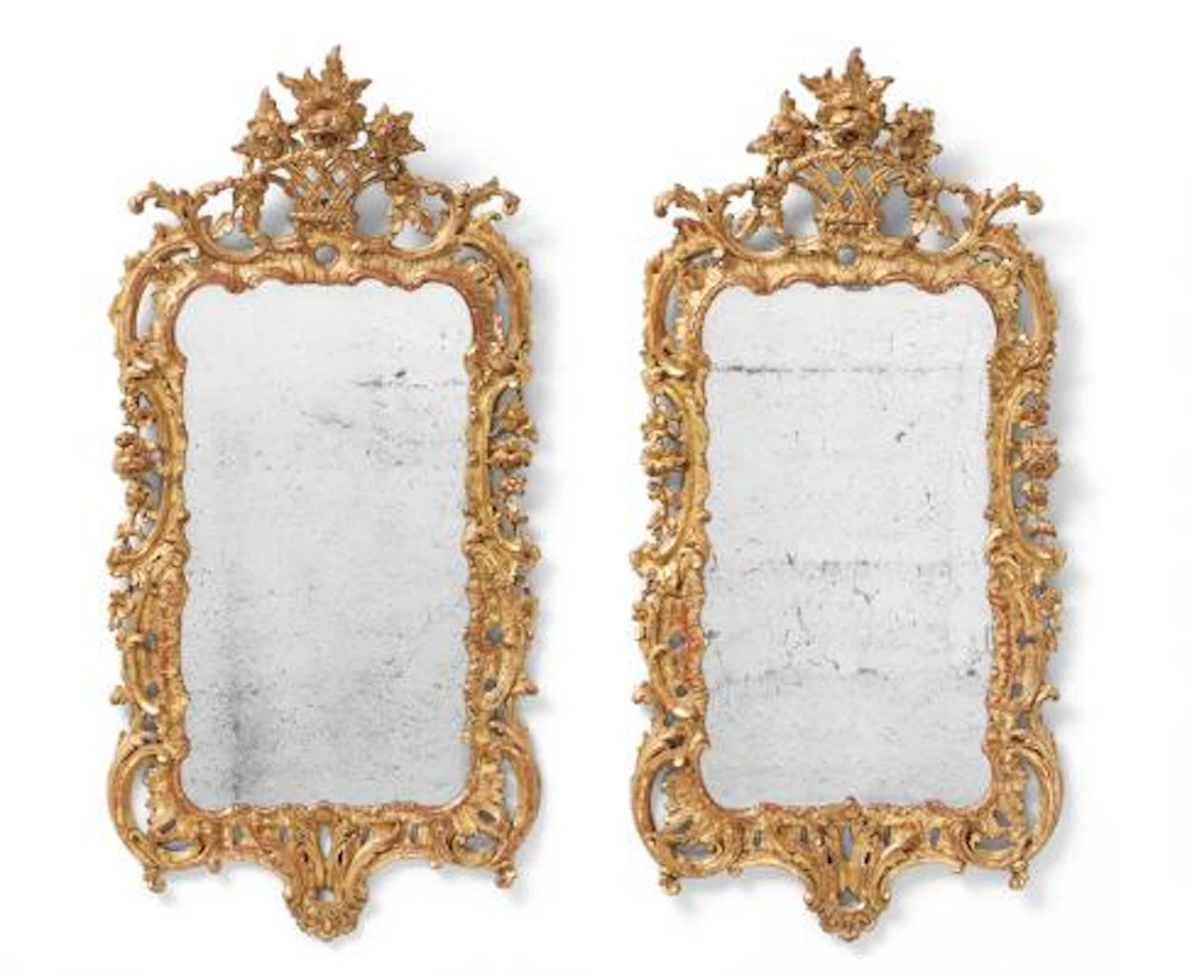 A pair of George III mirrors of gilded wood, pierced frames, each