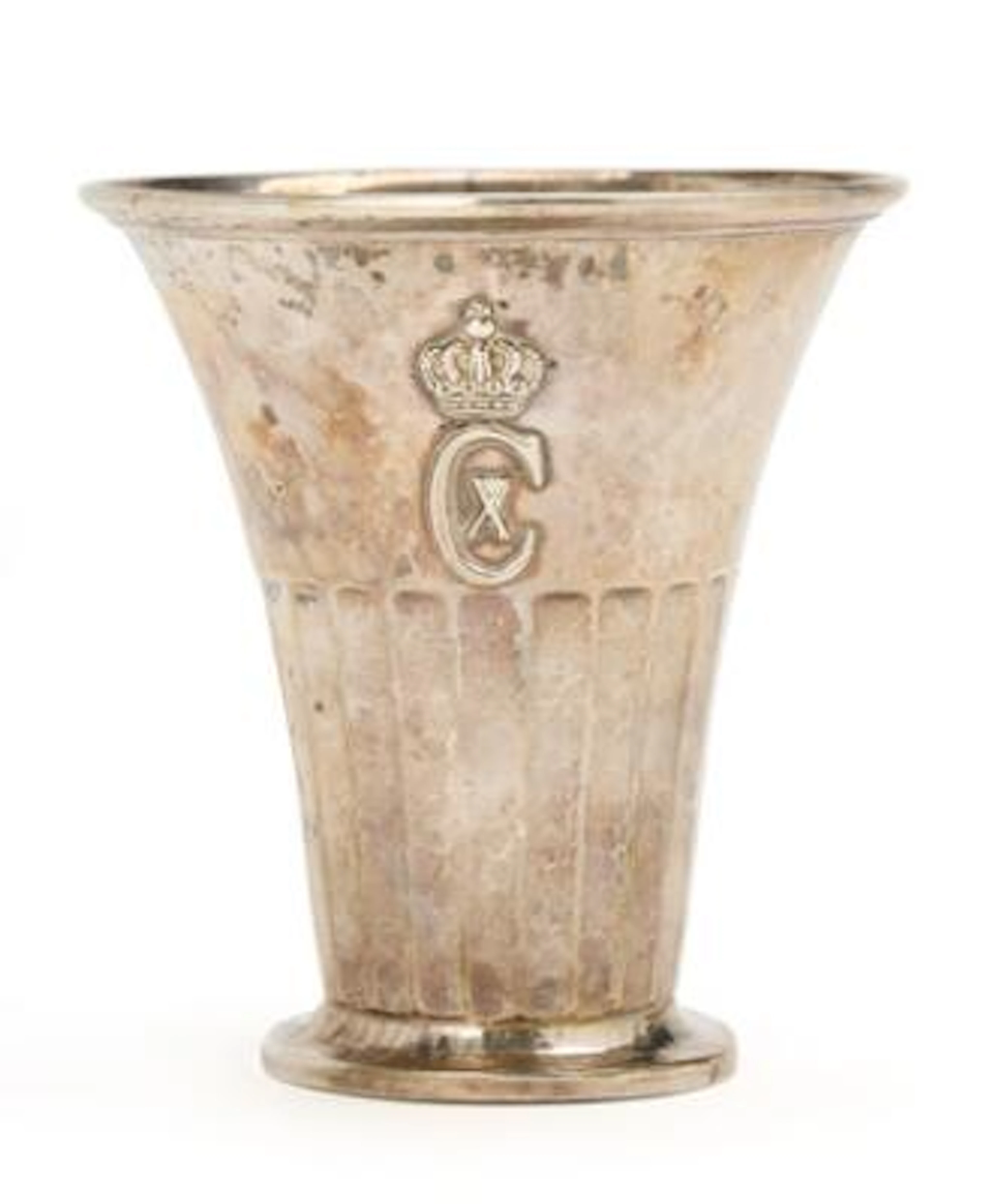 Beaker of hammered silver, conical form with partially faceted body.