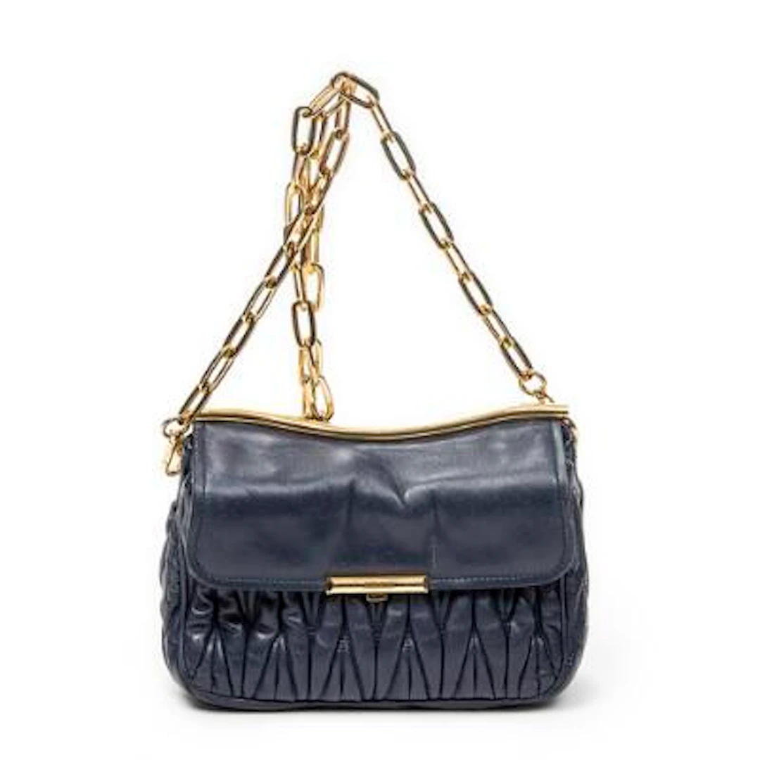 miu miu: A bag of dark blue pleated leather with gold tone hardware