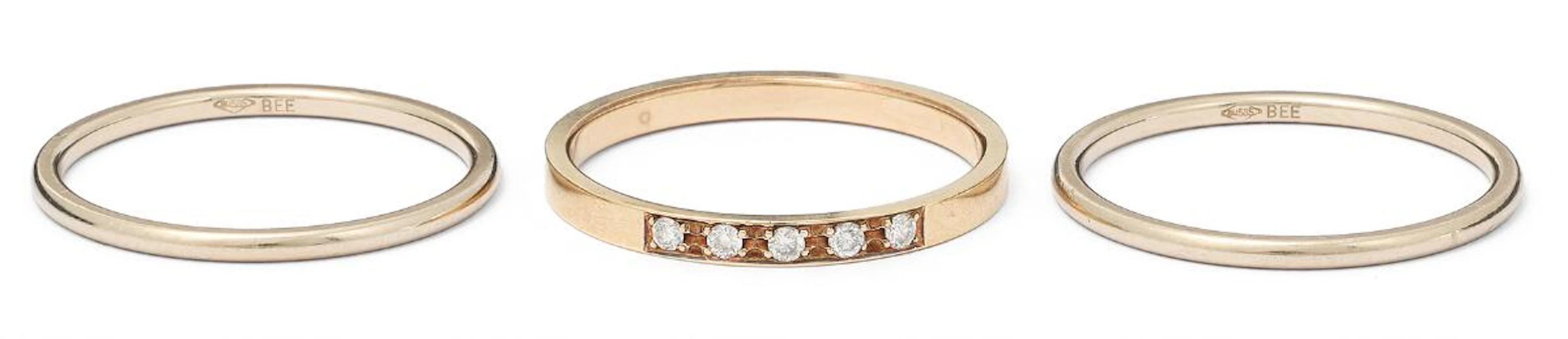 Three rings, one of which is set with five brilliant-cut diamonds