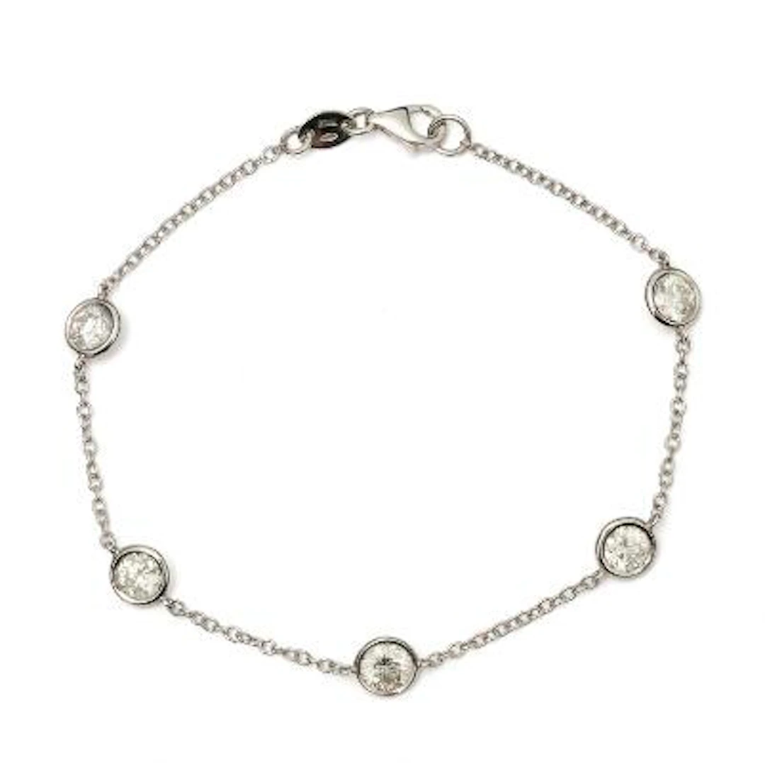 A diamond bracelet set with five diamonds mounted in 18k white gold.