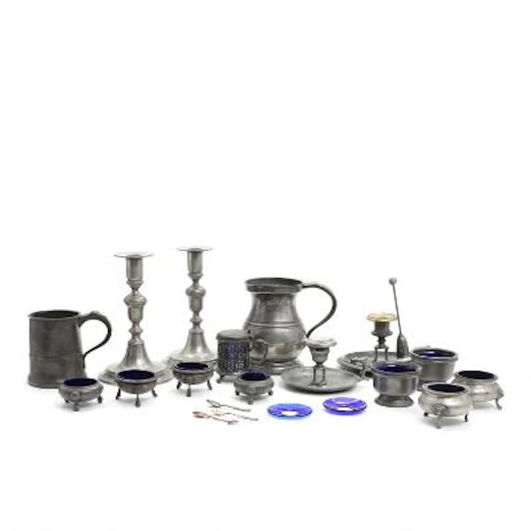 A collection of English pewter ware consisting of salt cellars, candlesticks