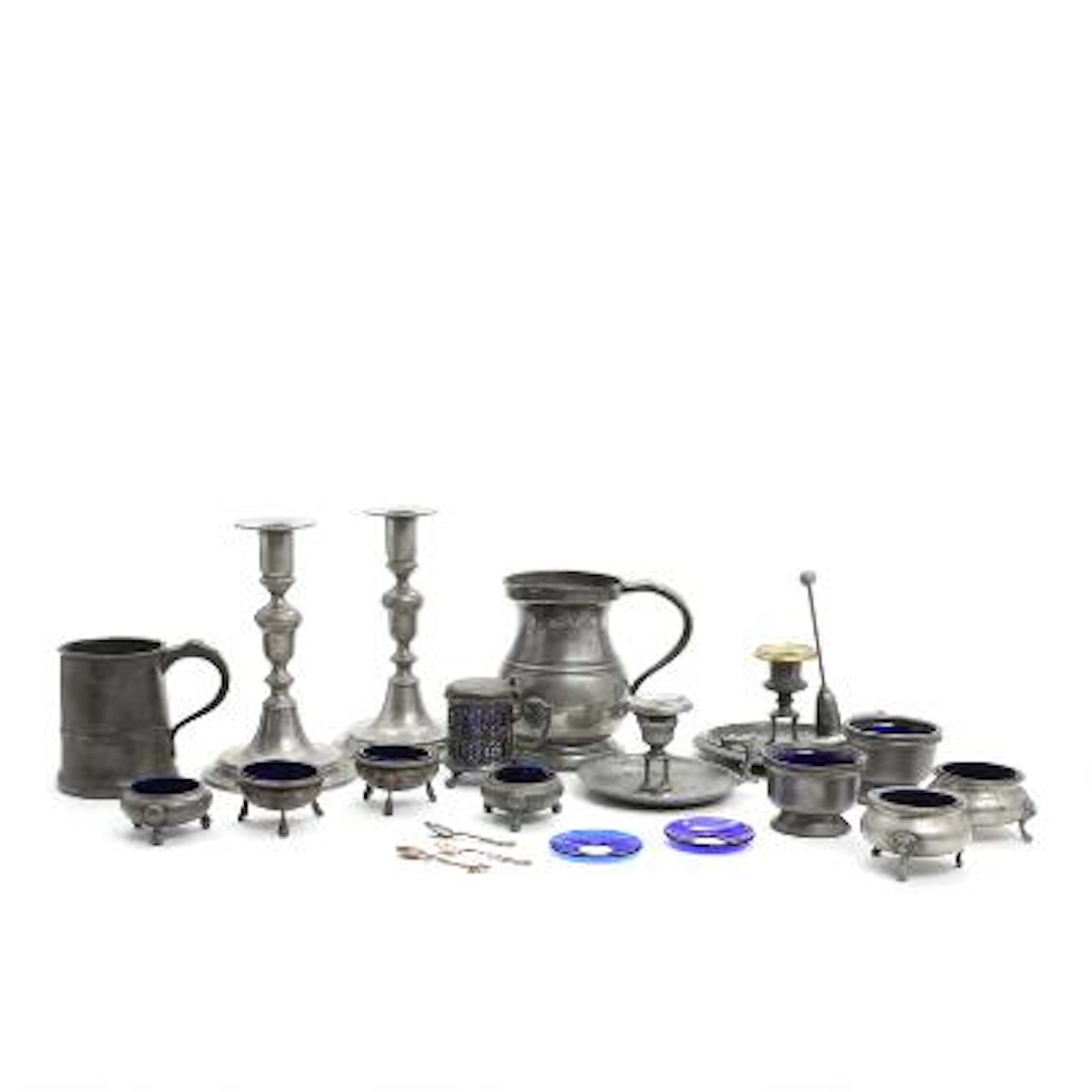 A collection of English pewter ware consisting of salt cellars, candlesticks