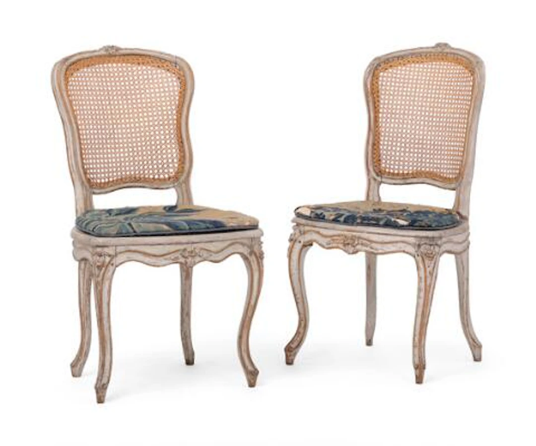 A pair of French rococo chairs of white-painted wood, back and seat
